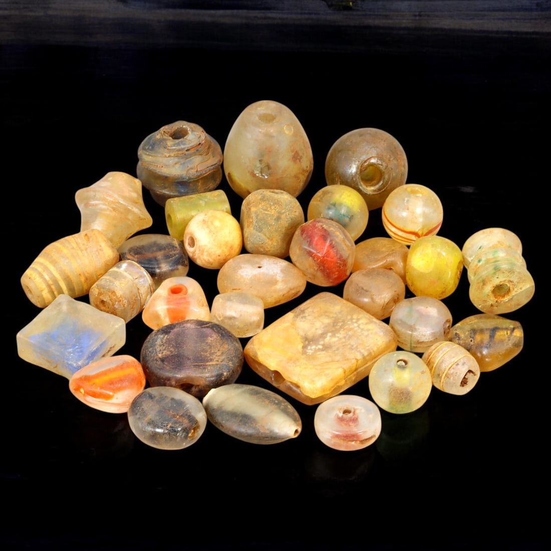 AFRICAN: Antique Mixed Glass Trade Beads, (175g, 1-3cm): This eclectic lot features African antique mixed glass trade beads, with a total weight of 175 grams and individual bead sizes ranging from 1 to 3 cm. The collection showcases a diverse array of shape