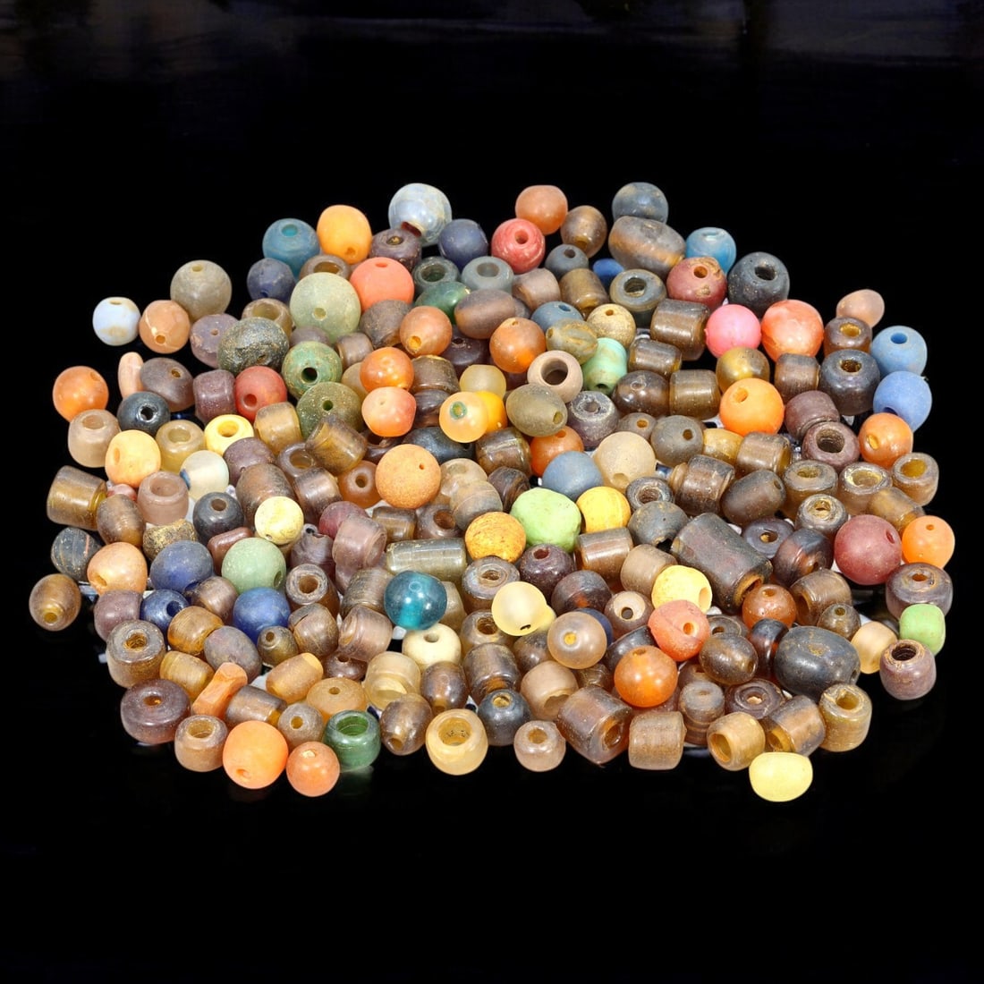 AFRICAN: Antique Mixed Glass Trade Beads, (207g, 6-14mm): This colorful lot features African antique mixed glass trade beads, with a total weight of 207 grams and individual bead sizes ranging from 6 to 14 mm. The collection showcases a vibrant array of cyli