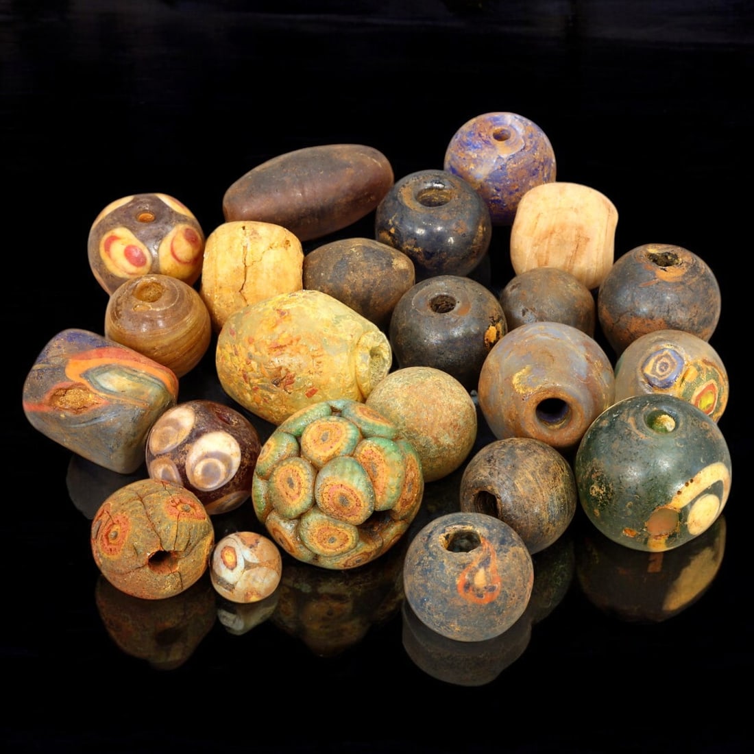 AFRICAN: Antique Mixed Polychrome Glass Eye Beads, (143g, 2-4cm): This intriguing lot features African antique mixed polychrome glass eye beads, with a total weight of 143 grams and individual bead sizes ranging from 2 to 4 cm. The collection showcases a variety of