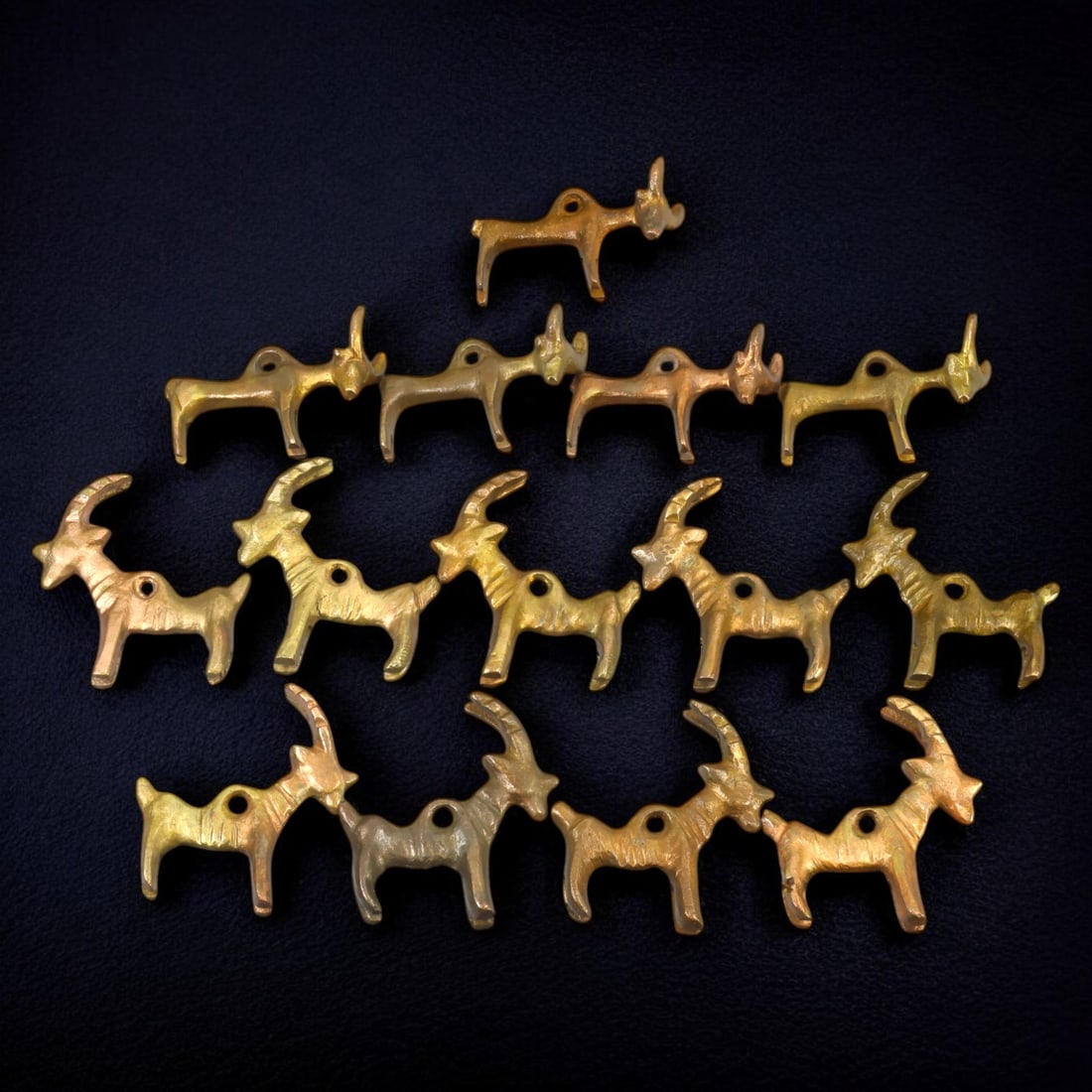 MONGOLIAN: Gold-Gilt Bovine Amulet Pendants, 18th-19th Century CE (270g, 5cm each): This captivating collection of gold-gilt bovine amulet pendants reflects traditional Mongolian craftsmanship from the 18th to 19th century CE. Each pendant, approximately 5 cm in length, is intricatel