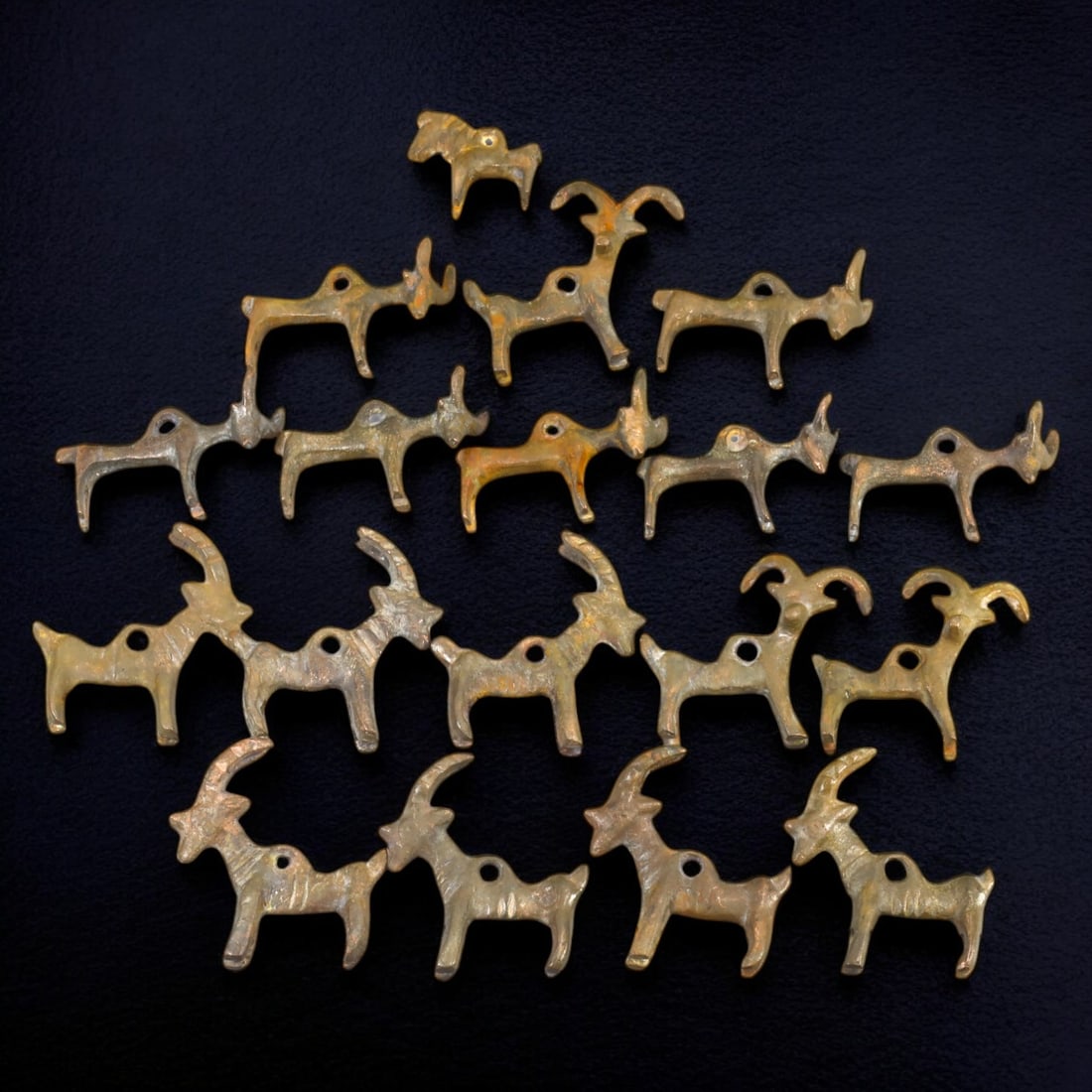 MONGOLIAN: Gold-Gilt Bovine Amulet Pendants, 18th-19th Century CE (329g, 5cm each): This captivating collection of gold-gilt bovine amulet pendants reflects traditional Mongolian craftsmanship from the 18th to 19th century CE. Each pendant, approximately 5 cm in length, is intricatel