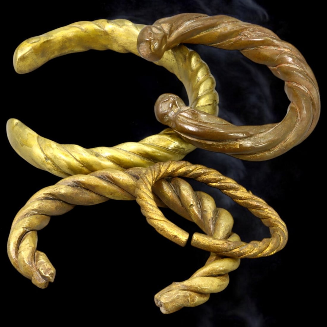 ANTIQUE BRONZE BRACELETS: Lot of Bronze Adornments (369g, 5-10cm): This lot features a collection of antique bronze bracelets, showcasing diverse styles and craftsmanship reflective of different cultural influences. The bracelets vary slightly in size and design, wit
