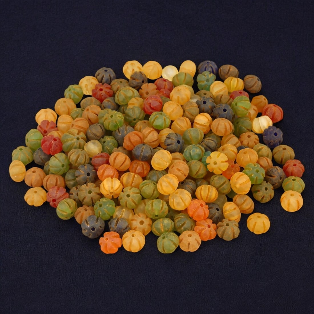 AFRICAN: Antique Carved Glass Beads, (251g, 12mm): This vibrant lot features African antique carved glass beads, with a total weight of 251 grams and individual beads measuring approximately 12mm in size. These intricately carved, multicolored beads r