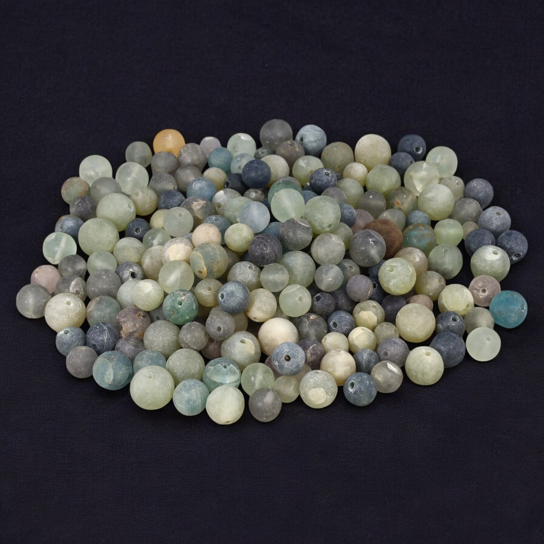 AFRICAN: Antique Glass Trade Beads, (895g, 1-2cm): This captivating lot features African antique glass trade beads, weighing a substantial 895 grams with individual beads ranging from 1 to 2 cm in size. These beads, crafted in a range of soft, earthy