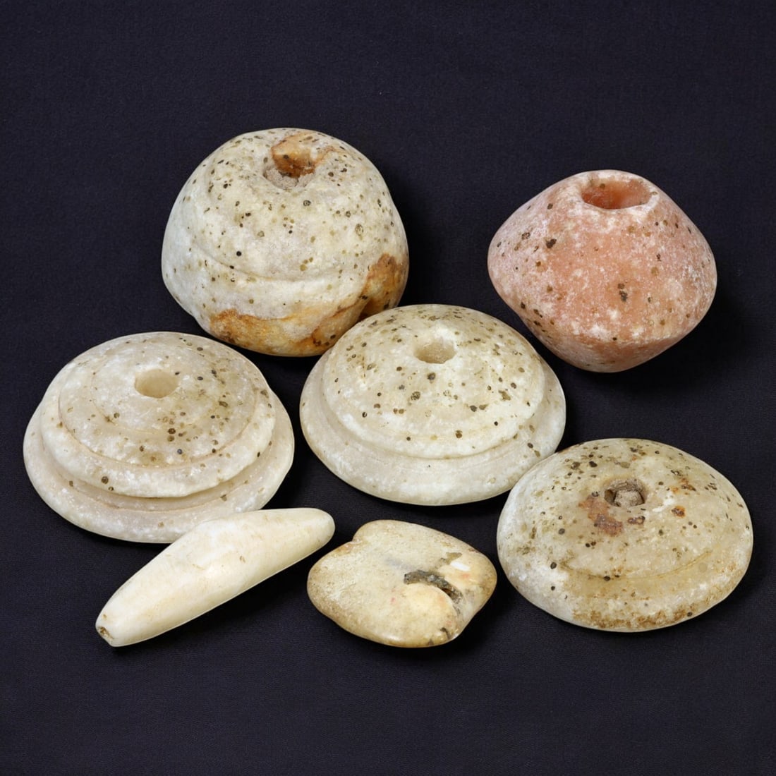 AFRICAN: Antique Stone Spindle Whorls and Beads, (93g, 2-4cm): This unique lot features African antique stone spindle whorls and beads, with a total weight of 93 grams and individual pieces ranging from 2 to 4 cm in size. Crafted from naturally weathered stone, t