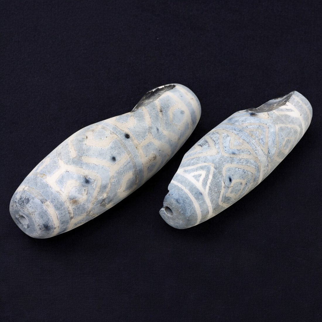 AFRICAN: Antique Etched Agate Dzi-Style Beads, (88g, 6-7cm): This captivating lot features African antique etched agate Dzi-style beads, with a total weight of 88 grams and individual beads measuring between 6 and 7 cm. Characterized by their elongated, cylindr