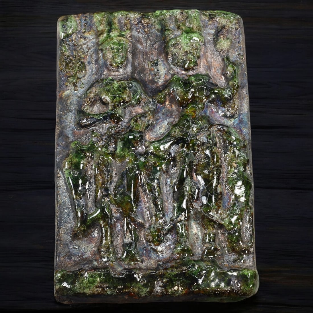 BUDDHIST TERRACOTTA VOTIVE PLAQUE: Glazed Iconographic Relief (526g, 18 x 12 cm): This striking Buddhist terracotta votive plaque features a vivid high-relief depiction of sacred figures, accentuated by a rich, iridescent glaze with green and earthy hues. The central composition li