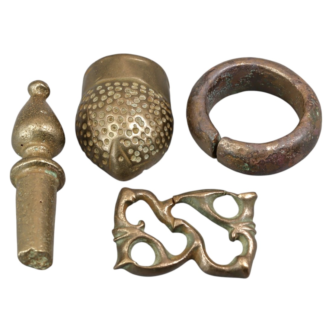 ANCIENT ROMAN: Bronze Artifacts, Roman Empire, 4pcs (83g, 3-5cm): This set of four Roman bronze artifacts showcases a variety of functional and decorative objects, including a ring-shaped piece, a belt fitting, a finial, and a stylized acorn-shaped ornament. Such ar