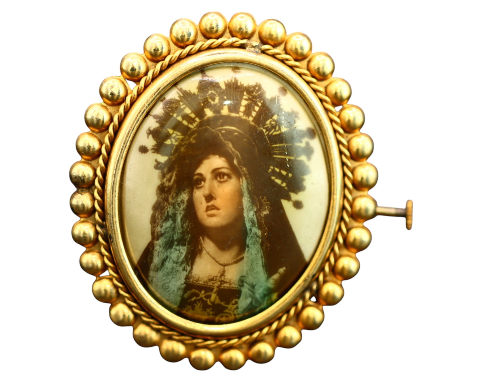 SPAIN: Virgen de la Esperanza Macarena Devotional Brooch - Gilt Metal & Glass, Early 20th Century: An elegant early 20th-century Spanish devotional brooch, featuring a beautifully preserved glass-encased portrait of the Virgen de la Esperanza Macarena, one of Seville's most revered Marian images. M