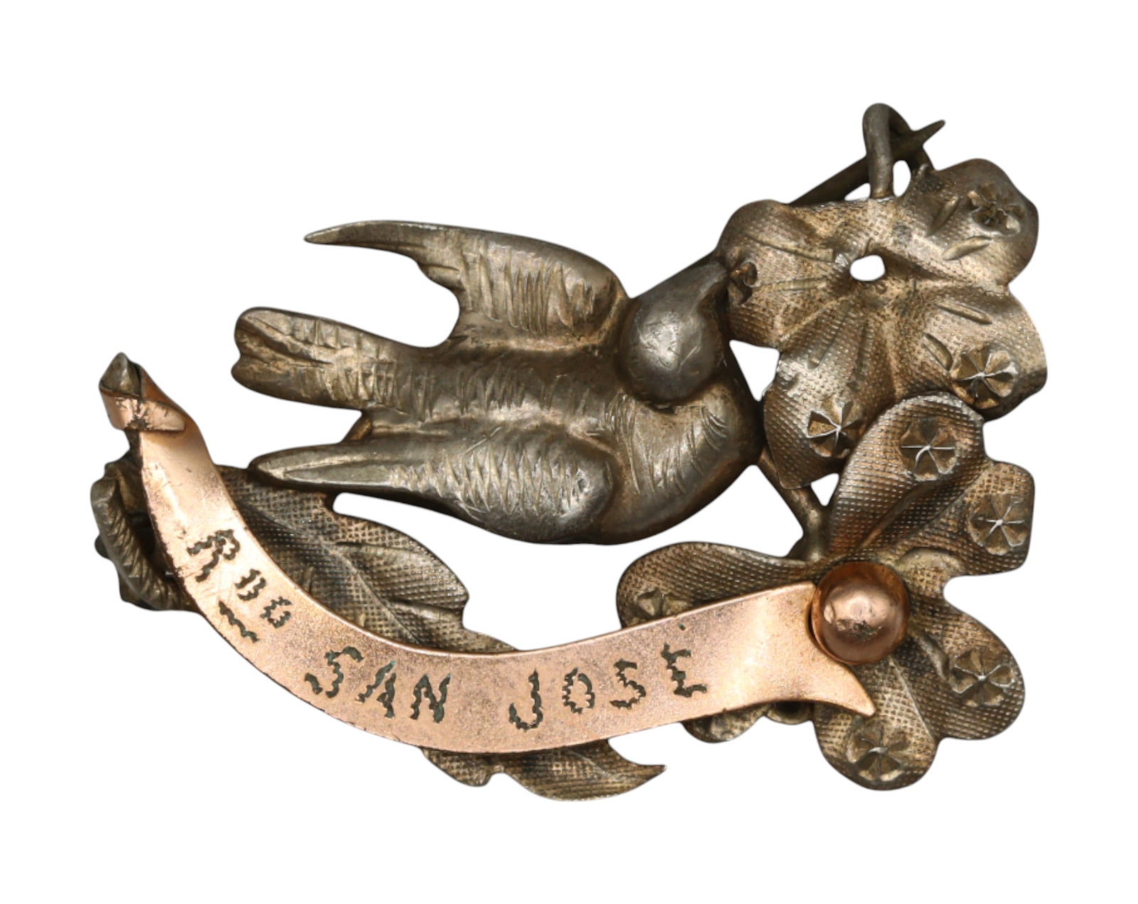 SPAIN: "Recuerdo de San Jose" Devotional Brooch - Silver & Copper, 19th-20th Century: A finely crafted silver and copper devotional brooch, measuring 2x3cm and weighing 2.6g, dedicated to San Jose (Saint Joseph). The piece features an elegantly sculpted swallow in flight, a symbol of h