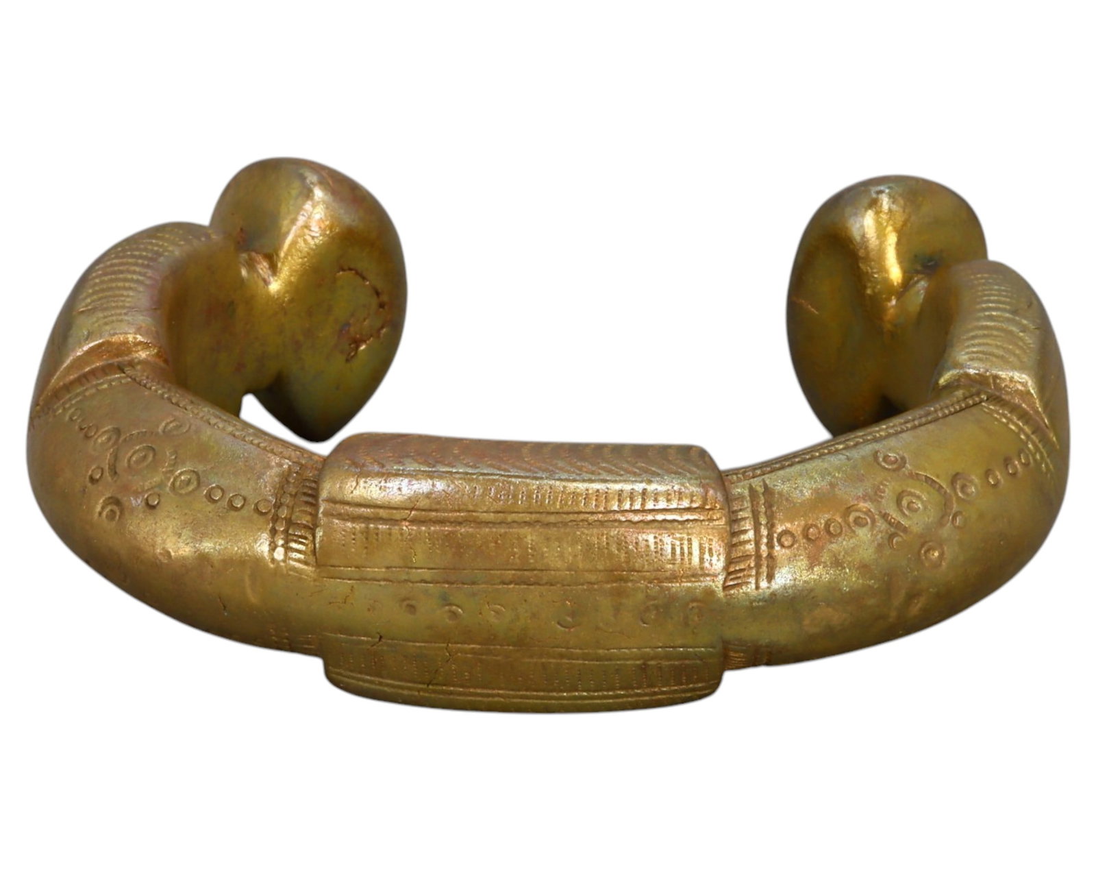 NIGERIA: King Manilla - Ornate Bronze Prestige Currency, 19th-20th Century: A heavily decorated King Manilla, cast in bronze, measuring 7.5 x 2 cm and weighing 270g. This piece features a thick, crescent shape with prominent, swollen terminals, characteristic of high-value ce