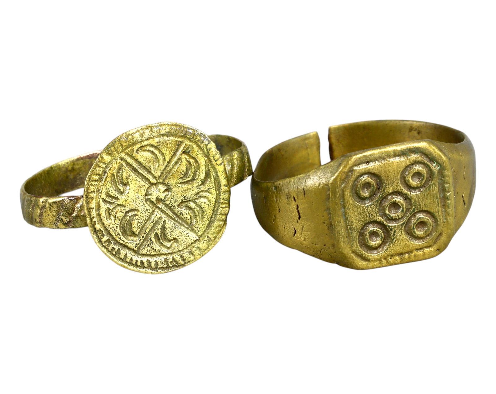MEDIEVAL EUROPE: Pair of Bronze Signet Rings - 10 US, 6.3g, 10th-13th Century AD: A remarkable pair of medieval bronze signet rings, dating from the 10th-13th century AD, each bearing intricate and symbolic designs. The first ring features a circular bezel with a finely engraved cr