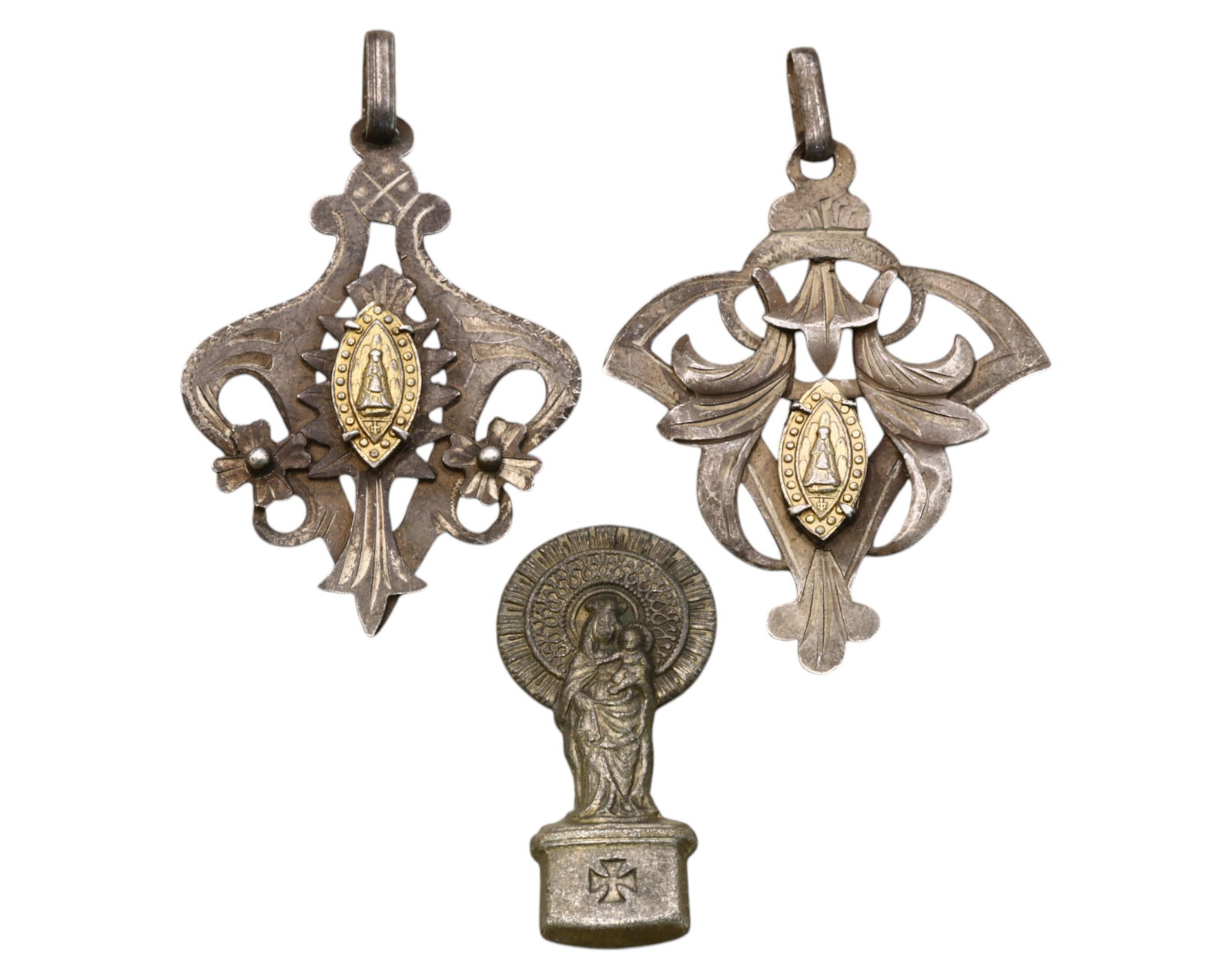 SPAIN: Set of Three Ornate Devotional Pendants - 18th-19th Century, 2.7-3.6cm, 5.3g: A magnificent set of three Spanish religious pendants, dating from the 18th to 19th centuries, crafted in silvered alloys with gold-gilded accents. These exquisitely detailed pieces feature intricate 