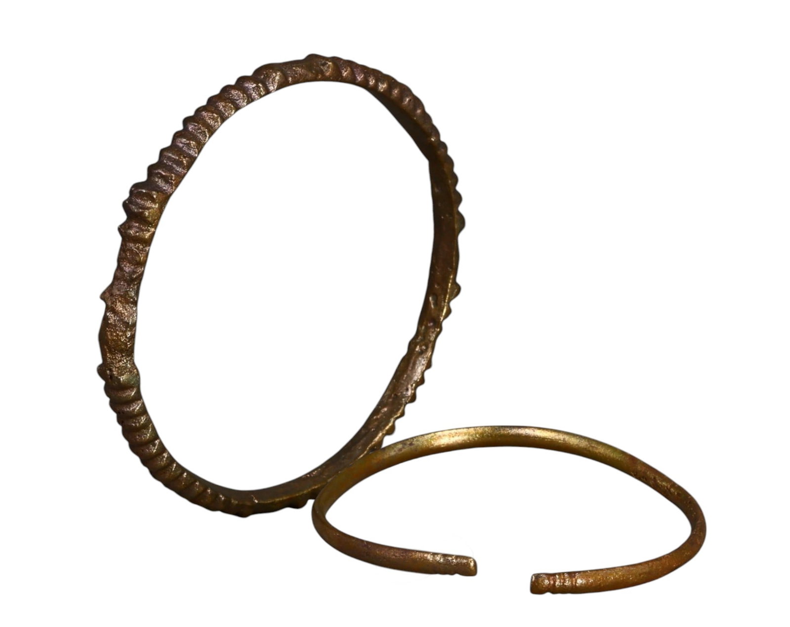WEST AFRICA: Edo-Benin Kingdom Brass Currency Manillas (Pair), c. 16th-19th Century: A compact yet historically valuable pair of Edo-Benin Kingdom brass manilla currency pieces, measuring 5.5cm and 6.4cm in diameter with a combined weight of 30g. One piece features a ridged, textured 