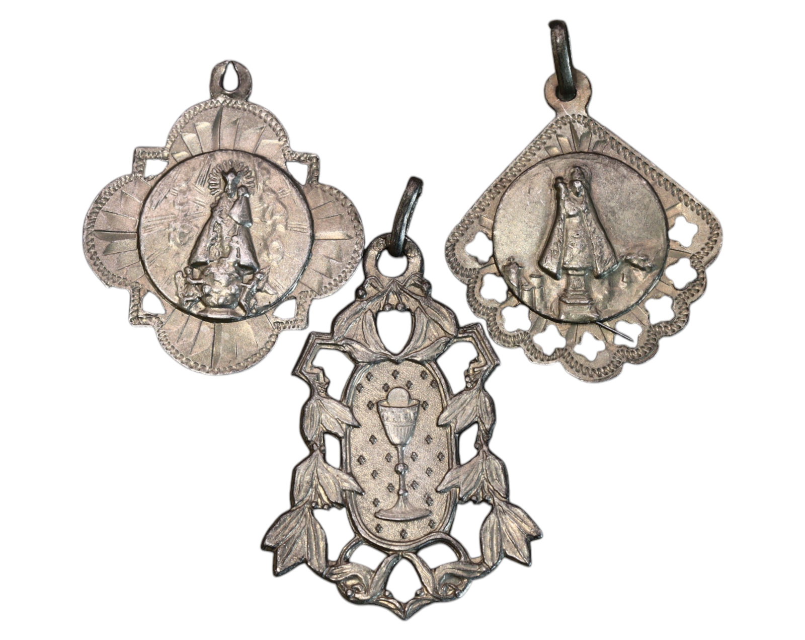 SPAIN: Set of Three Silver Devotional Medals - Virgin of Desamparados & Remei, 2.8-3.3cm, 6.8g: An elegant trio of Spanish silver devotional medals, intricately designed to honor Nuestra Se?ora de los Desamparados (Our Lady of the Forsaken) and Nuestra Se?ora del Remei (Our Lady of Remedy). The 