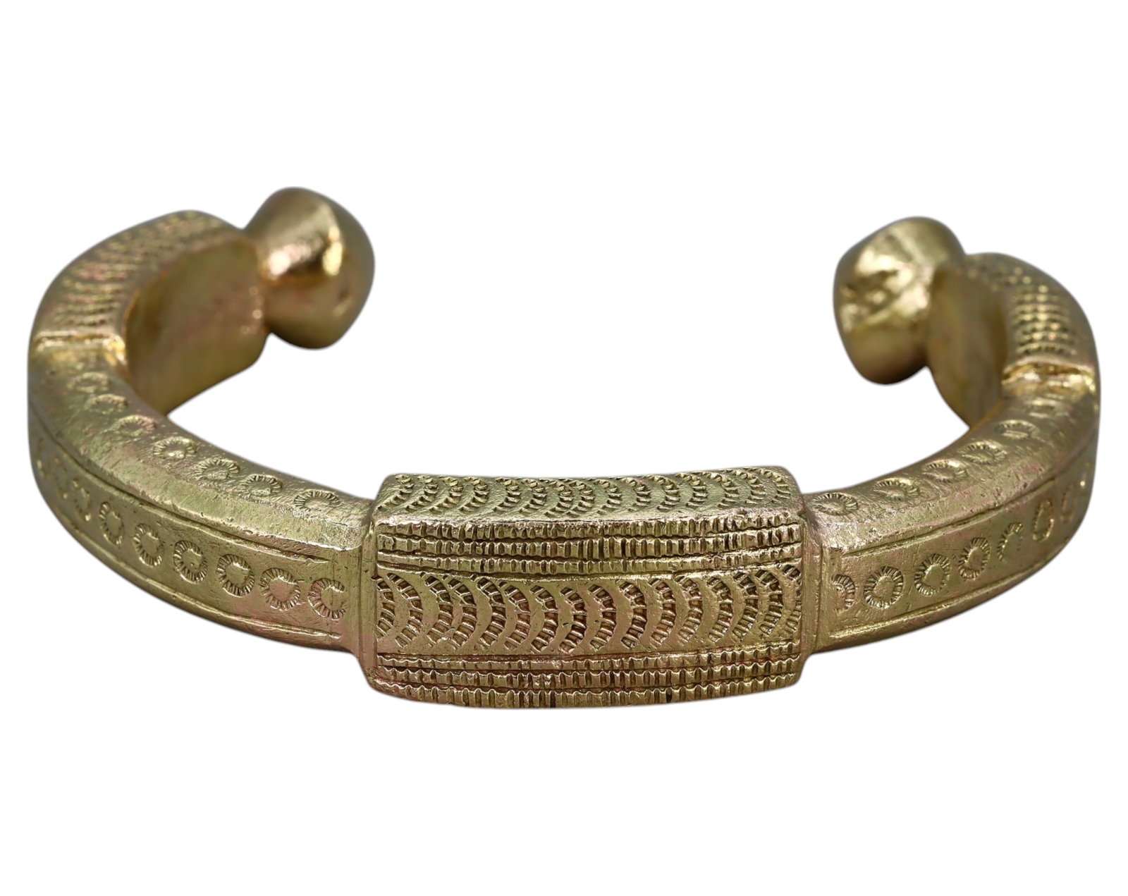 WEST AFRICA: King's Brass Manilla Bracelet - Ornate Currency & Prestige Symbol: An exquisite King's Manilla bracelet, cast in brass, measuring 7.3x1.3cm and weighing 104g. Adorned with intricate geometric and circular patterns, this piece represents both currency and status in th
