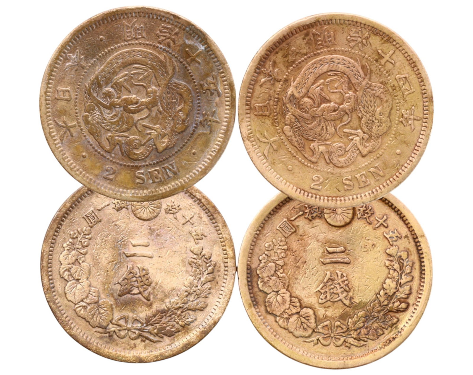 JAPAN: Lot of 2 Bronze 2 Sen Coins - Meiji Era, 1881 & 1882: A pair of well-preserved Japanese 2 Sen coins from the Meiji era, dated Year 14 (1881) and Year 15 (1882). Each coin is struck in bronze, collectively weighing 28g with a diameter of 3cm. The obverse 