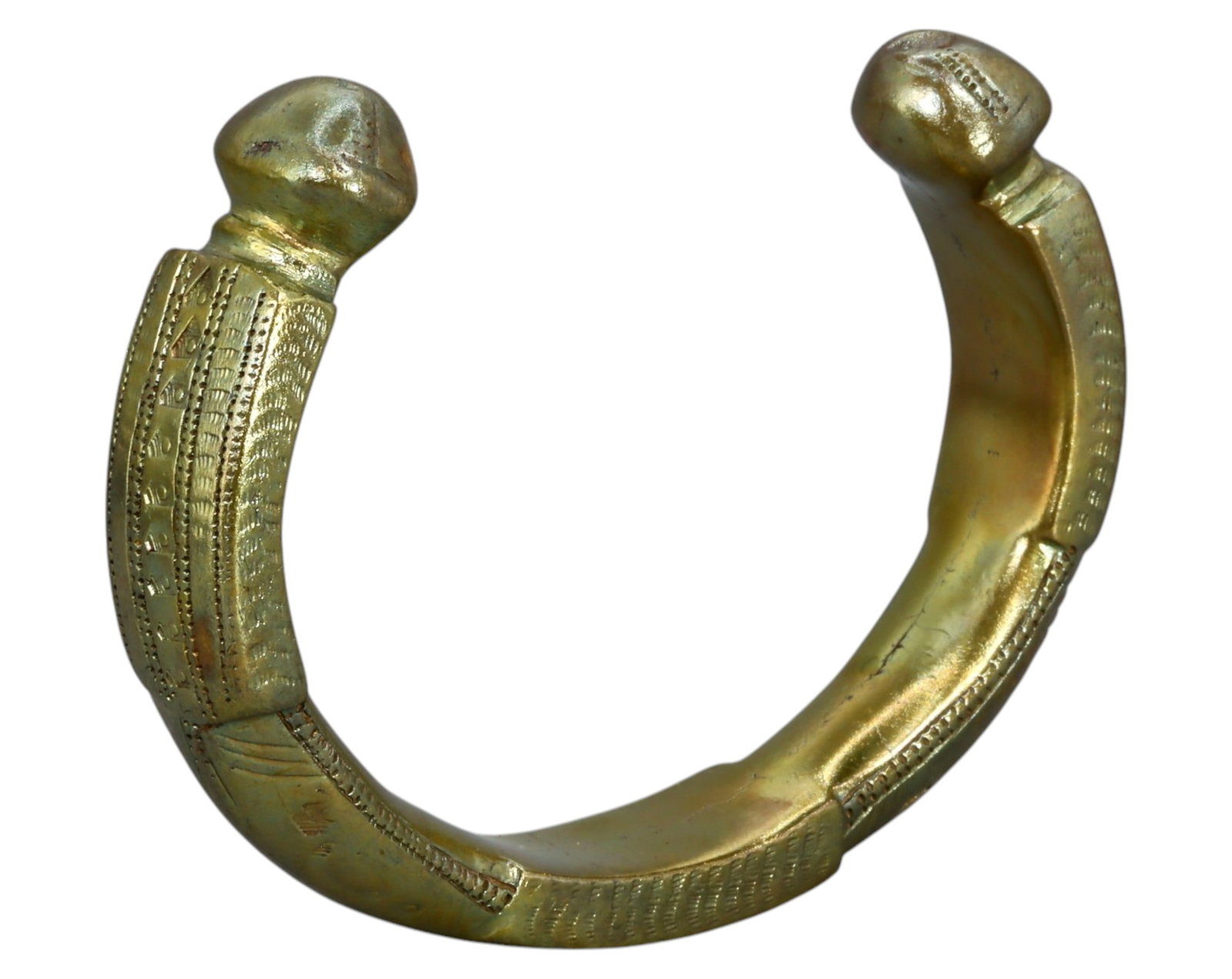 WEST AFRICA: Decorated Manilla Trade Currency - Bronze, 18th-19th Century: A well-preserved West African bronze manilla, measuring approximately 8 cm in diameter, 1.5 cm thick, and weighing 159g. This finely crafted piece features an array of detailed engravings along its cu