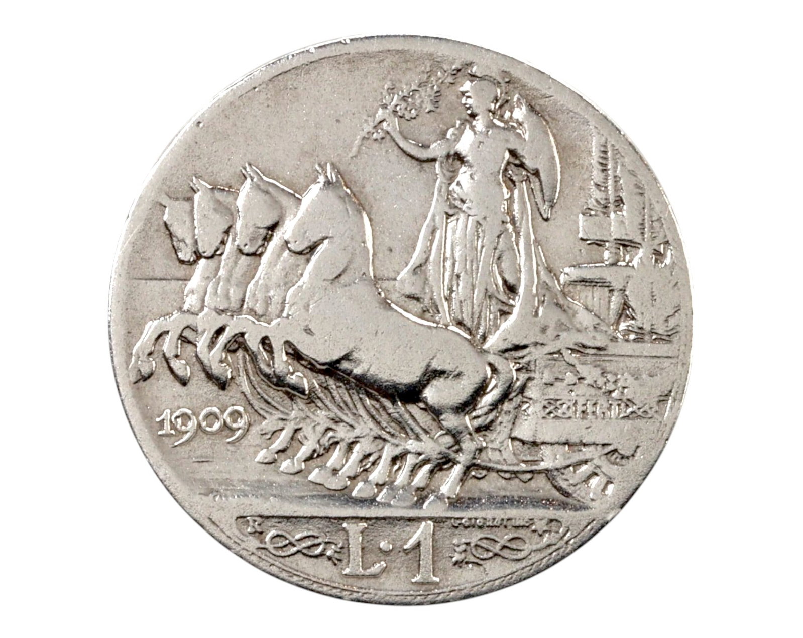 ITALY: Vittorio Emanuele III Silver 1 Lira Coin - Quadriga Reverse, 1909: A classic Italian silver 1 Lira coin from 1909, struck under the reign of Vittorio Emanuele III. Weighing 4.9g with a diameter of 23mm, this coin features a distinguished right-facing portrait of the 
