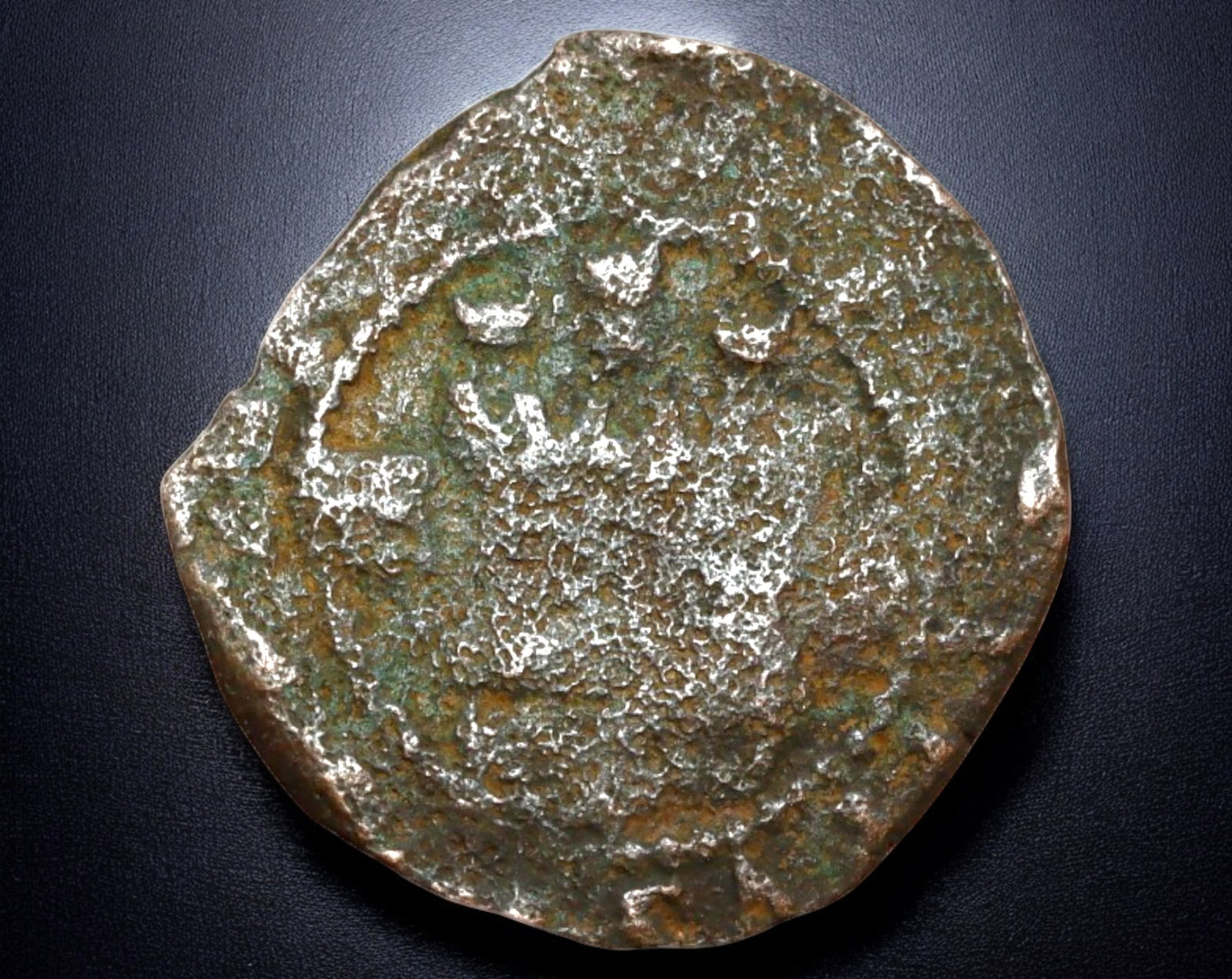 SPAIN: Philip II Copper Maravedis - Coruna Mint, 1556-1598: A 22mm, 3.7g copper maravedis struck during the reign of Philip II of Spain (1556-1598) at the Coruna Mint. The obverse displays a crowned monogram of Philip II, surrounded by remnants of the original