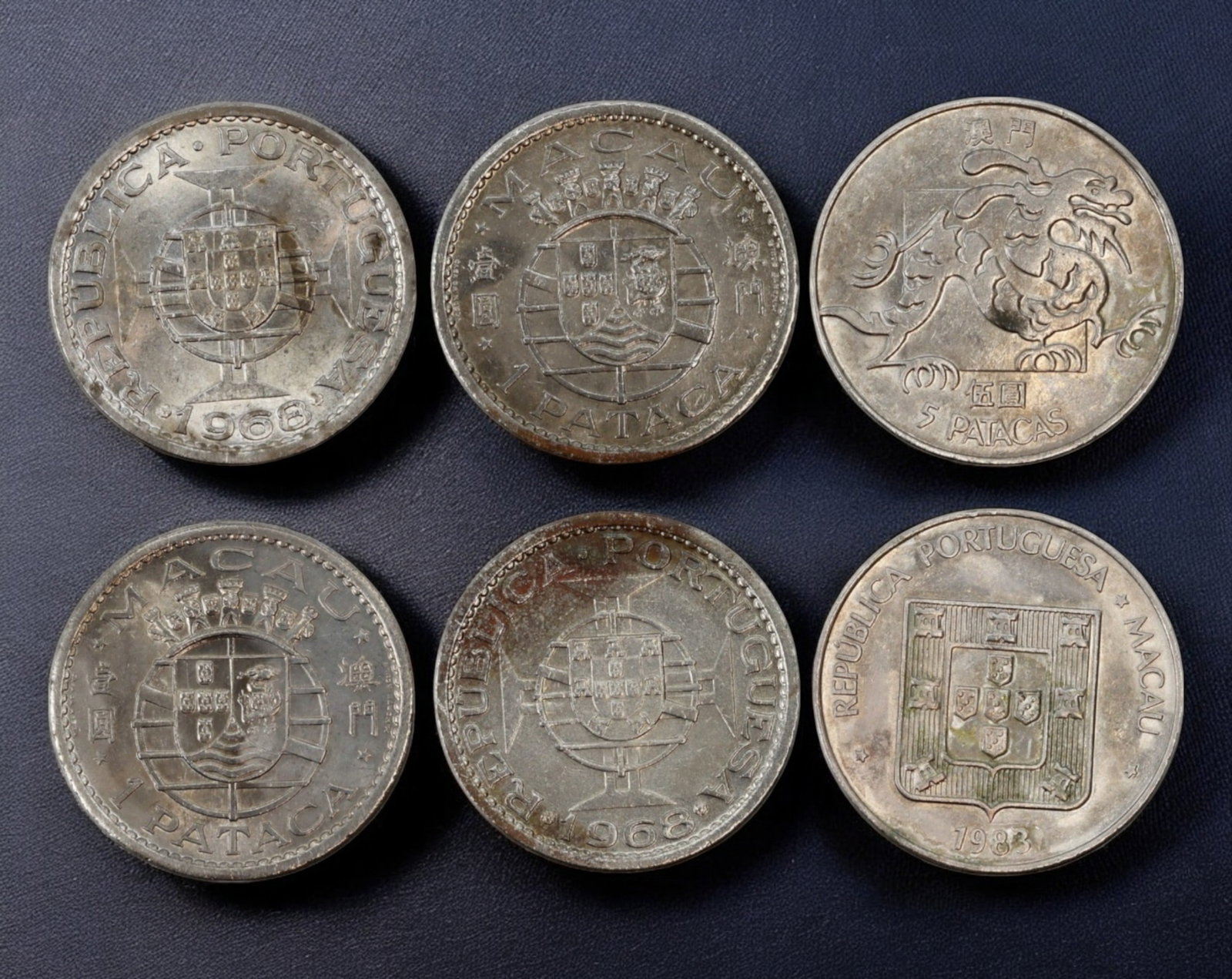 PORTUGUESE MACAU: Silver & Nickel Pataca Coins - 3pcs, 28-29mm, 32g Total: A distinguished trio of Portuguese Macau Pataca coins, reflecting the colonial era before the 1999 handover to China. These coins, struck in silver and nickel, feature the Portuguese coat of arms on t