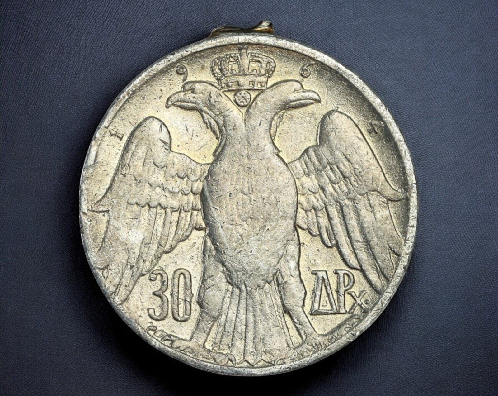 GREECE: 30 Drachmai Coin - Constantine II & Paul I, 1963: A historically significant 30 Drachmai coin, issued in 1963 to commemorate the royal lineage of Greece. Struck in a copper-nickel alloy, this piece measures 30mm in diameter and weighs 11.9g. The obve