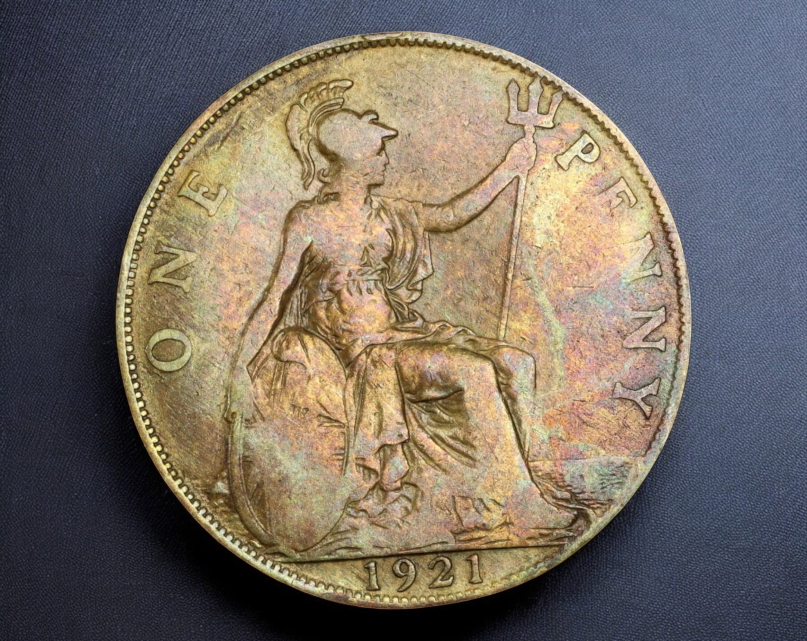 UNITED KINGDOM: George V Bronze Penny Coin - 1921: A 1921 British one Penny Coin struck in bronze, measuring 30mm in diameter and weighing 9.2g. The obverse features the right-facing bust of King George V, with the surrounding Latin legend "GEORGIVS V