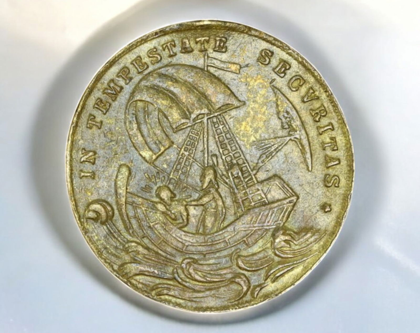 EUROPE: Saint George & "IN TEMPESTATE SECURITAS" Medal - Brass, 2cm, 2.6g, 18th-19th Century: A small yet finely detailed Saint George devotional medal, struck in brass, measuring 2 cm in diameter and weighing 2.6g. The obverse depicts Saint George slaying the dragon, a traditional symbol of C