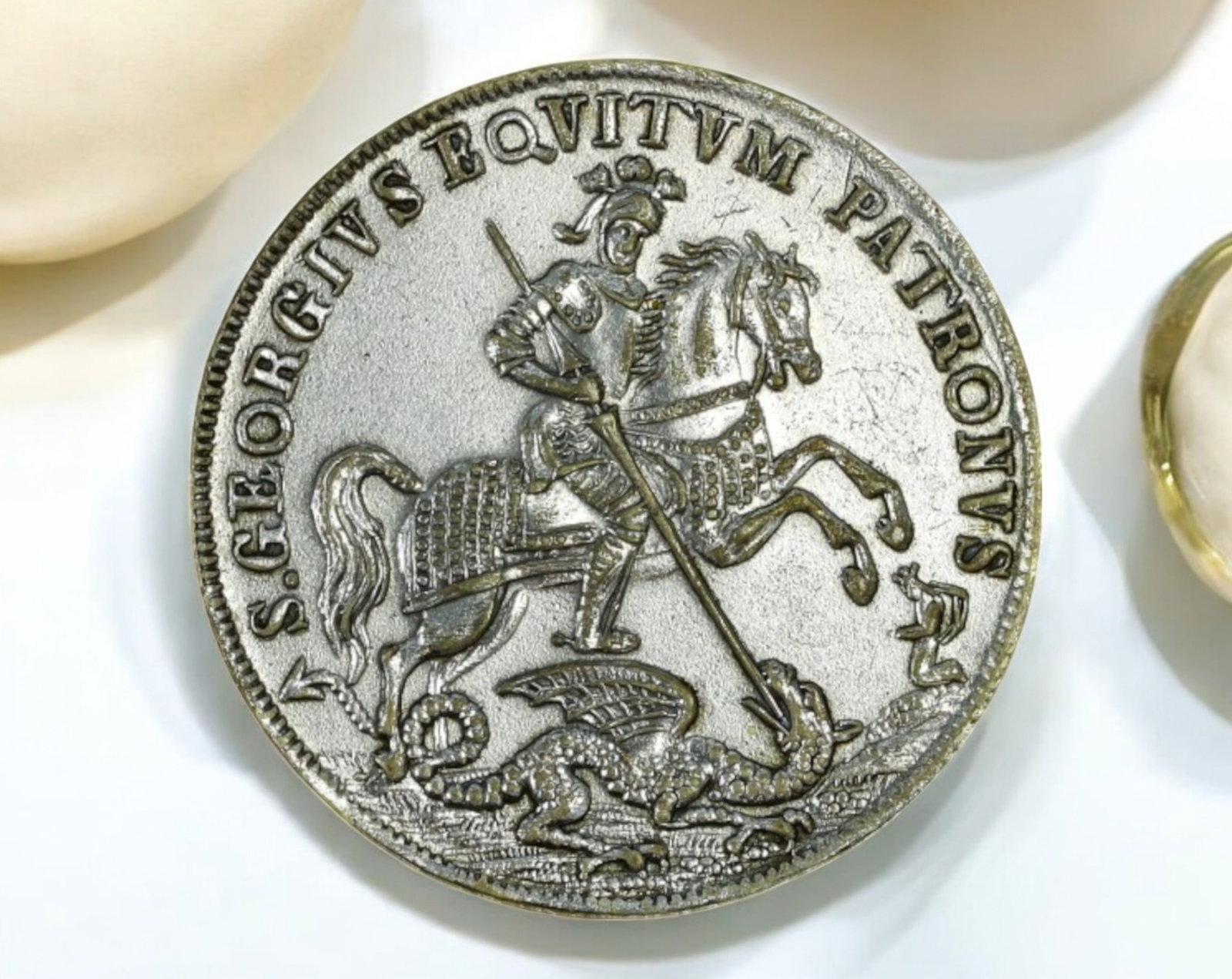 EUROPE: St. George & Maritime Protection Medal Coin- Silvered, 19th Century: A finely crafted silvered medal, measuring 27mm in diameter and weighing 5.2g, featuring a dynamic depiction of Saint George slaying the dragon. Encircled by the Latin inscription "S. GEORGIVS EQVITVM
