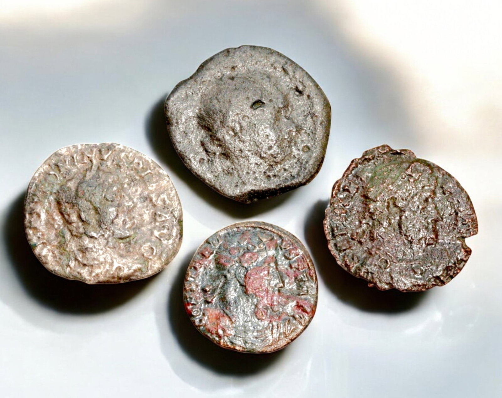 ROMAN EMPIRE: AE Coins - Bronze Coins, 15-18mm, 9.7g (Lot of 4): A collection of four ancient Roman bronze coins, each featuring a distinct imperial portrait on the obverse and various symbolic or military-themed reverses. These coins, essential to Roman commerce a