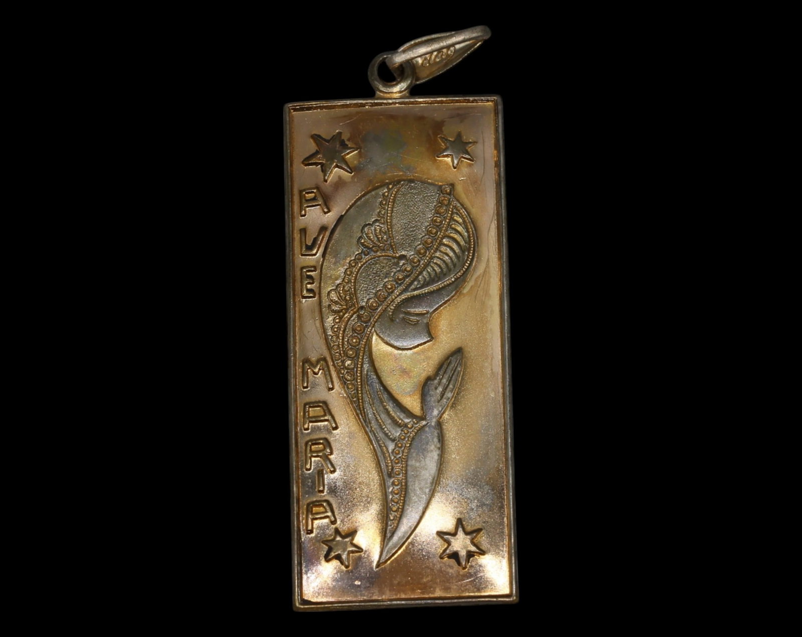 ITALY: Silver Devotional Pendant - Ave Maria, Art Deco Style: A striking silver devotional pendant featuring an elegant Art Deco-inspired depiction of the Virgin Mary in profile, her veiled head adorned with intricate detailing, radiating a sense of divine grace