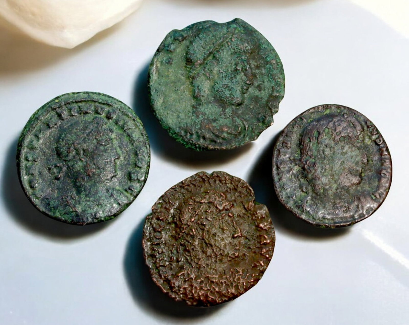 ROMAN EMPIRE: AE Coins - Bronze Coins, 15-18mm, 8.6g (Lot of 4): A collection of four ancient Roman bronze coins, each featuring a distinct imperial portrait on the obverse and various symbolic or military-themed reverses. These coins, essential to Roman commerce a