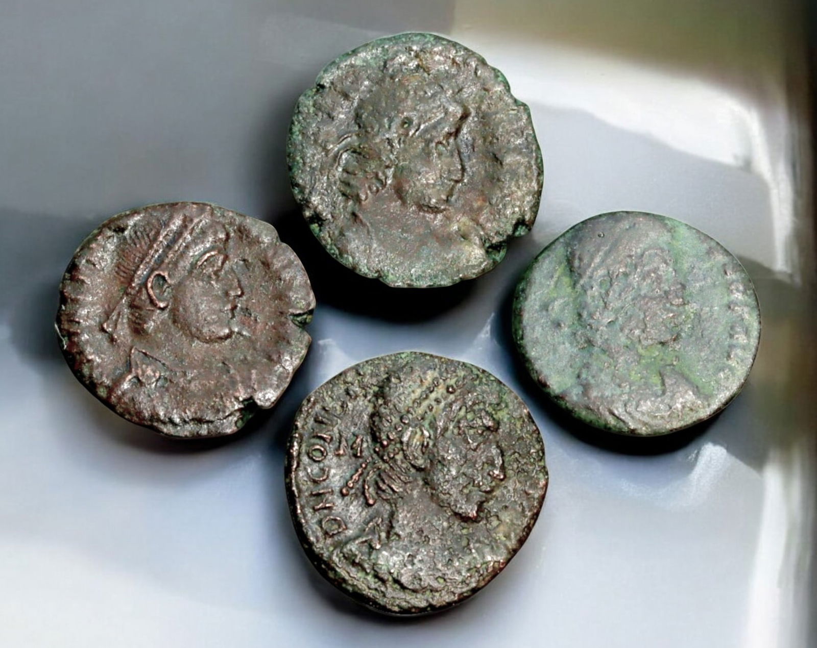 ROMAN EMPIRE: AE Coins - Bronze Coins, 15-17mm, 10.2g (Lot of 4): A collection of four ancient Roman bronze coins, each featuring a distinct imperial portrait on the obverse and various symbolic or military-themed reverses. These coins, essential to Roman commerce a
