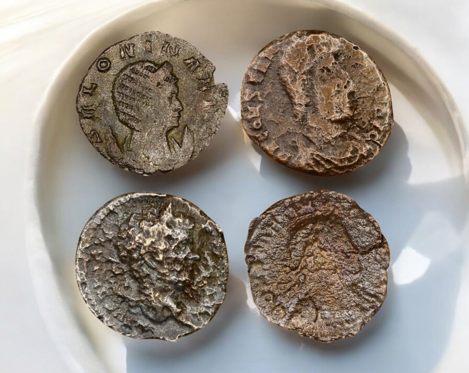 ROMAN EMPIRE: Lot of 4 Late Roman Bronze AE Coins 17-18mm, c. 3rd-5th Century AD: A mixed lot of four late Roman bronze AE coins, representing the turbulent era of the later empire. These coins likely feature emperors from the 3rd to 5th centuries AD, a period marked by military cr