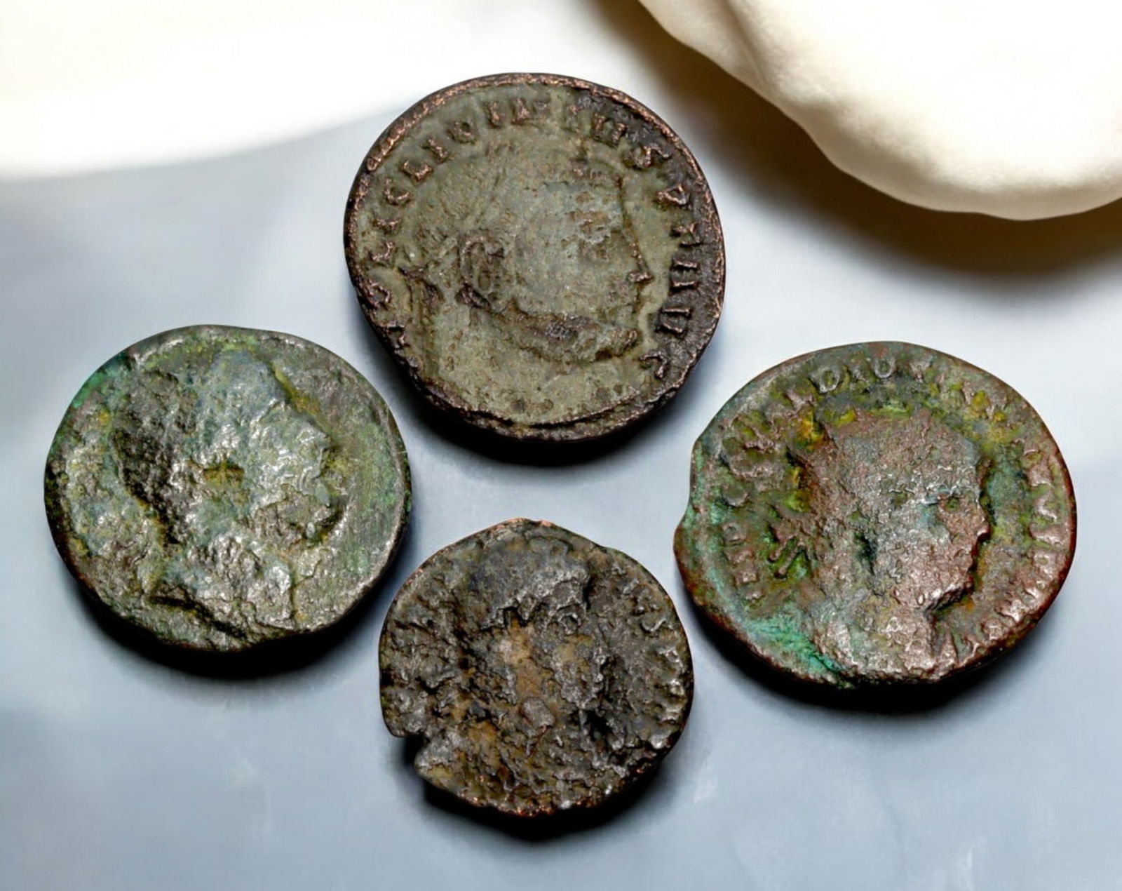 ROMAN EMPIRE: AE Coins - Bronze Coins, 17-21mm, 10.8g (Lot of 4): A collection of four ancient Roman bronze coins, each featuring a distinct imperial portrait on the obverse and various symbolic or military-themed reverses. These coins, essential to Roman commerce a