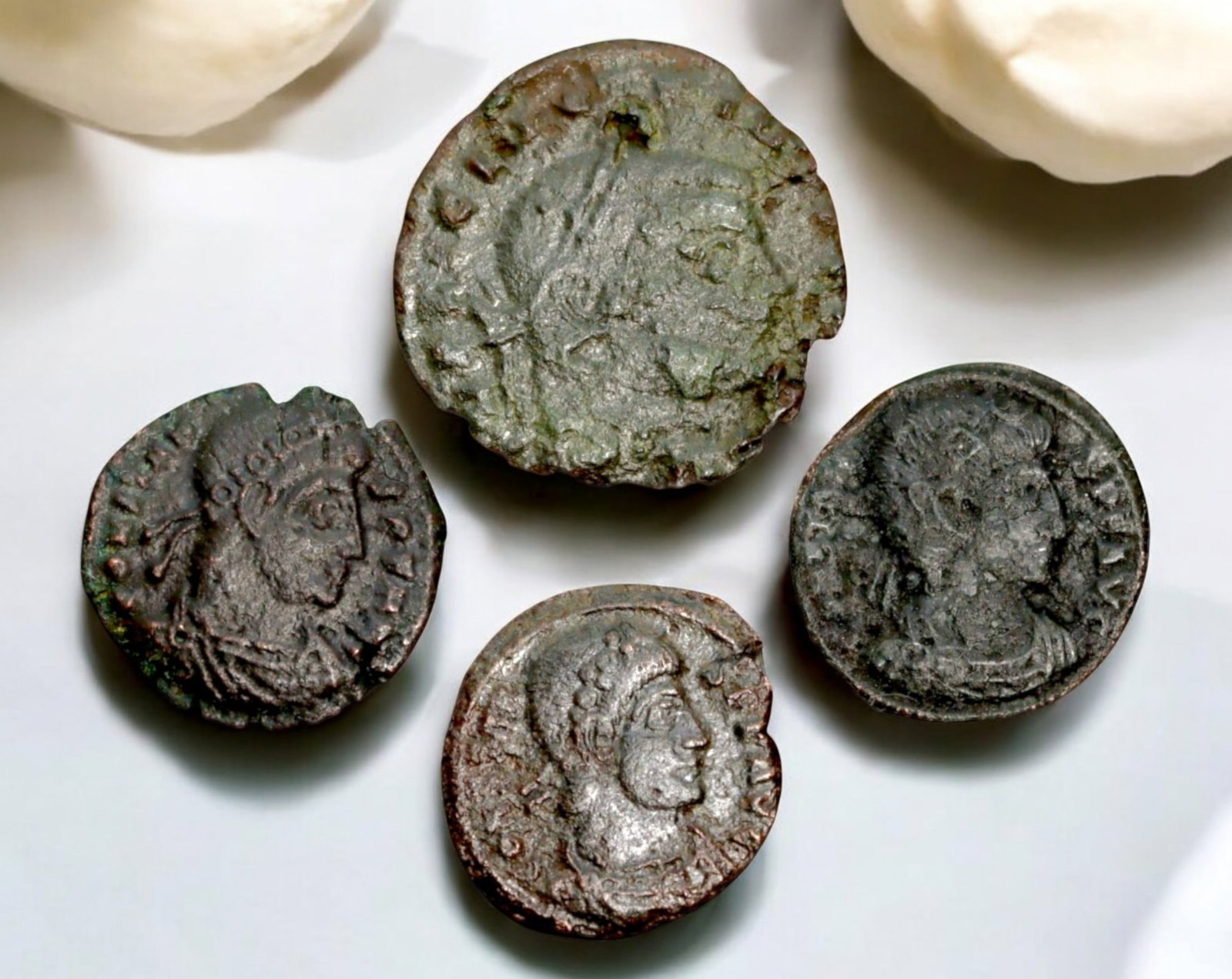 ROMAN EMPIRE: AE Coins - Bronze Coins, 16-20mm, 5.8g (Lot of 4): A collection of four ancient Roman bronze coins, each featuring a distinct imperial portrait on the obverse and various symbolic or military-themed reverses. These coins, essential to Roman commerce a