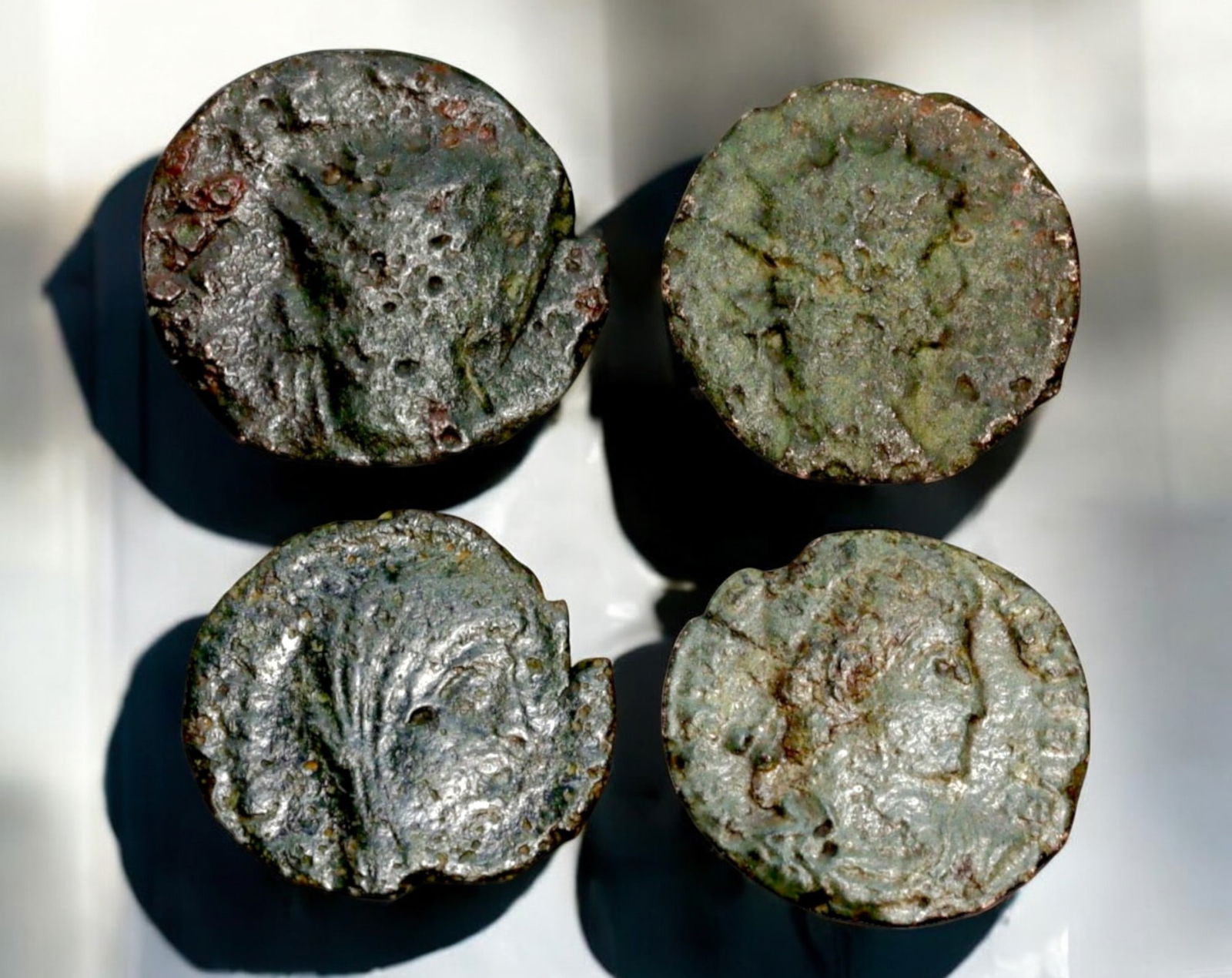 ROMAN EMPIRE: AE Coins - Bronze Coins, 14-17mm, 6.9g (Lot of 4): A collection of four ancient Roman bronze coins, each featuring a distinct imperial portrait on the obverse and various symbolic or military-themed reverses. These coins, essential to Roman commerce a