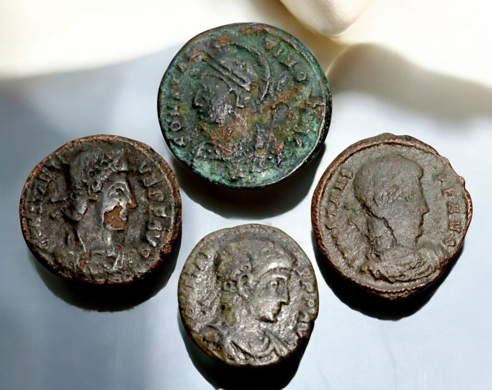ROMAN EMPIRE: AE Coins - Bronze Coins, 15-17mm, 7.2g (Lot of 4): A collection of four ancient Roman bronze coins, each featuring a distinct imperial portrait on the obverse and various symbolic or military-themed reverses. These coins, essential to Roman commerce a