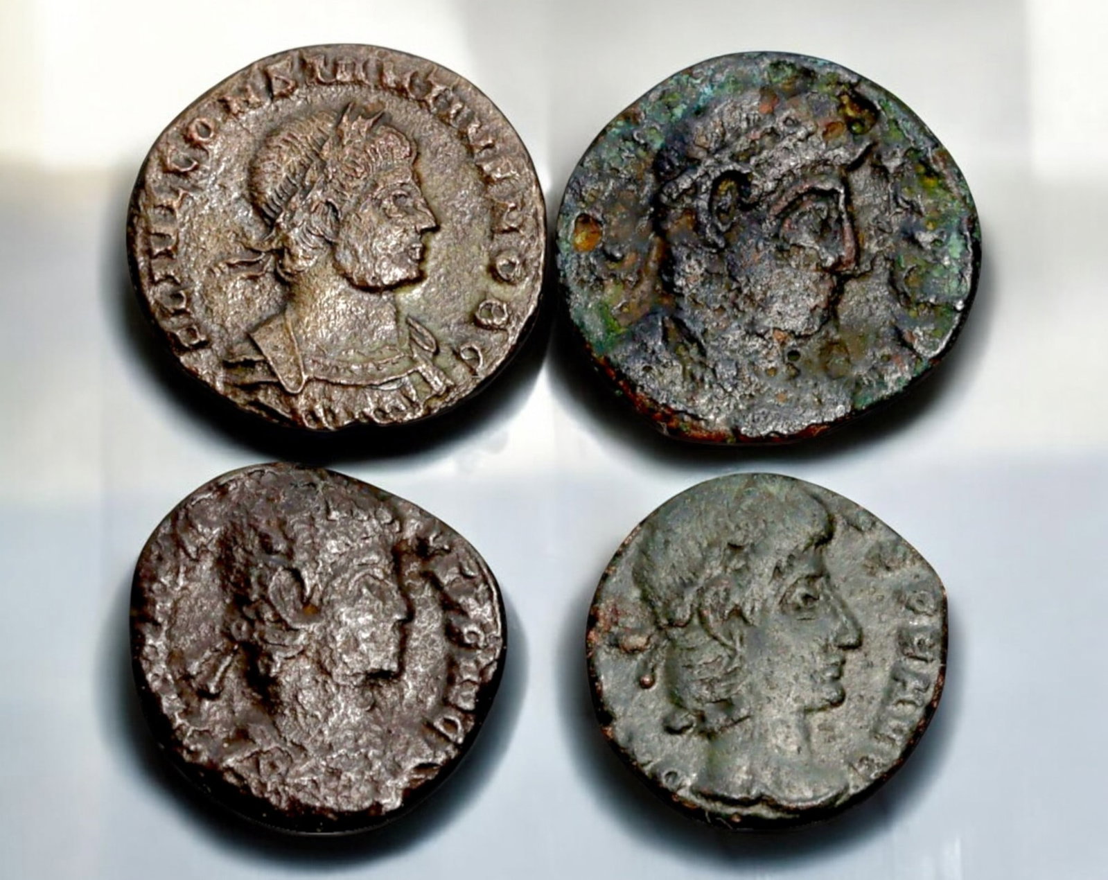 ROMAN EMPIRE: AE Coins - Bronze Coins, 14-17mm, 7.2g (Lot of 4): A collection of four ancient Roman bronze coins, each featuring a distinct imperial portrait on the obverse and various symbolic or military-themed reverses. These coins, essential to Roman commerce a