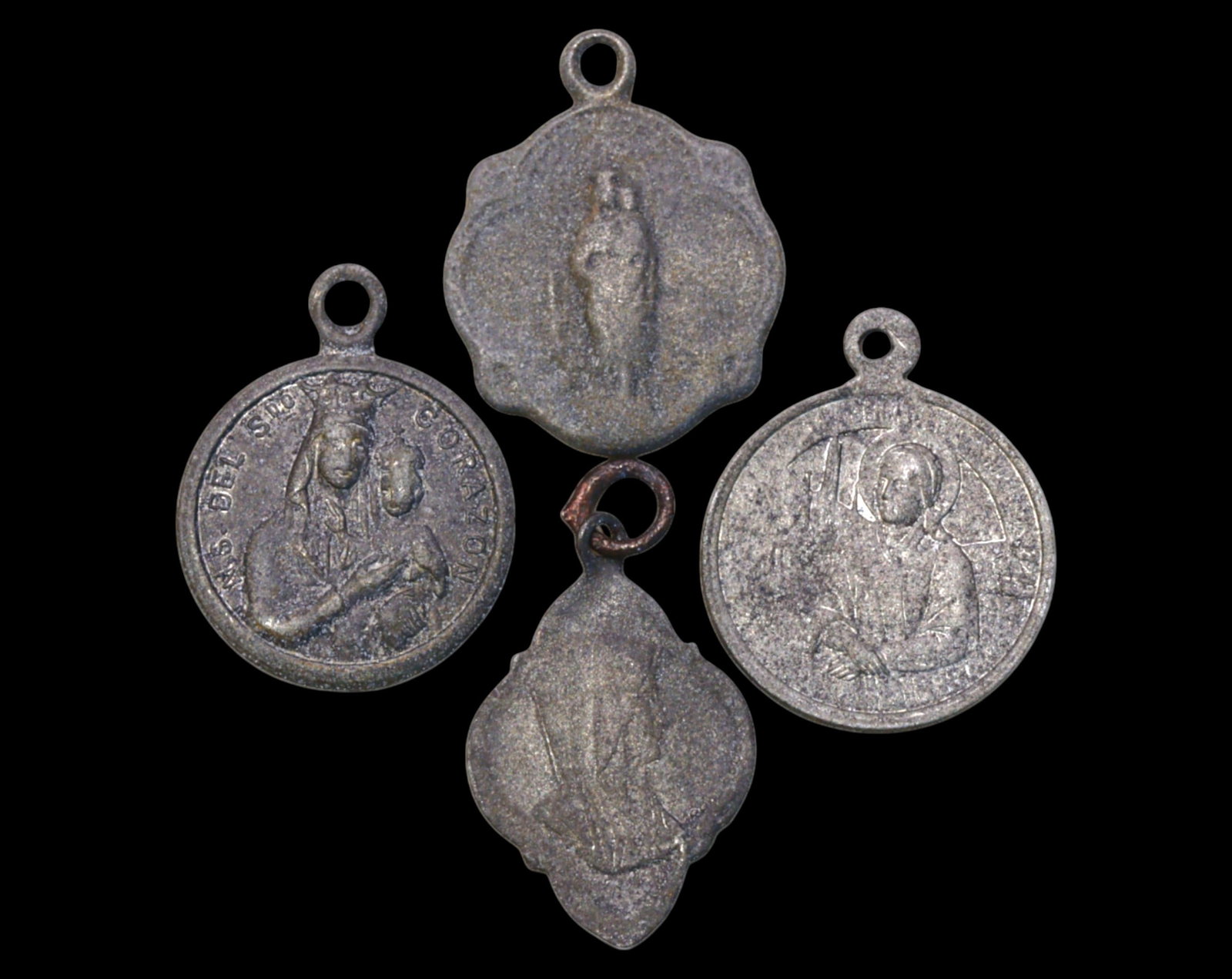 SPAIN: Set of Four Small Devotional Medals - 19th-20th Century, 1.9-2cm, 1.7g: A finely detailed set of four Spanish devotional medals, each showcasing revered religious iconography. This collection includes an image of the Virgin and Child, likely representing Our Lady of the S