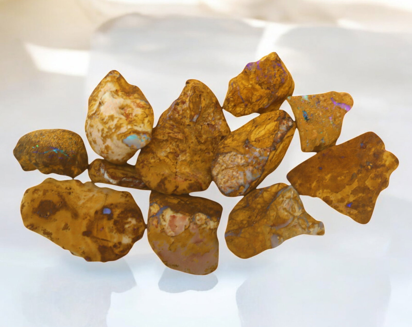 AUSTRALIA: Queensland Fossilized Crystal Opal Rough Lot, 1-3.7cm, 79g (Images Taken Wet): A striking lot of natural fossilized crystal opal rough, sourced from Queensland, Australia. These specimens display an impressive blend of earthy ironstone matrix and vibrant flashes of opalescence, 