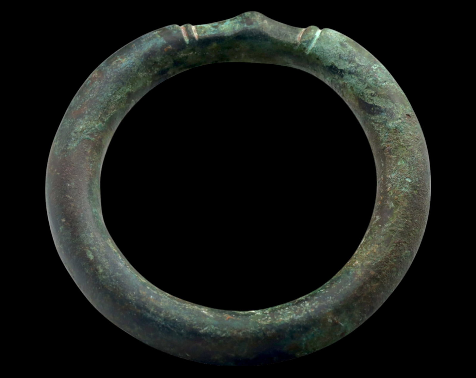 WEST AFRICA: Solid Bronze Currency Bracelet - 8cm, 213g, Circa 16th-19th Century: A substantial West African bronze currency bracelet, measuring 8cm in diameter and weighing 213g. This piece is crafted with a thick, rounded form and subtle incised markings near the apex, indicative