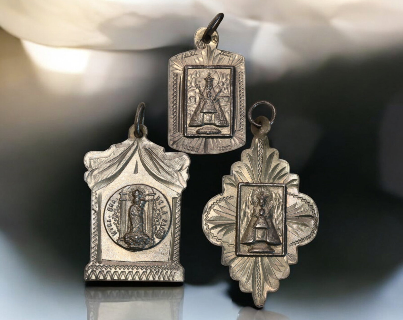 SPAIN: Virgin of Montserrat Silver Religious Medals - 19th Century (Set of 3): A beautifully crafted set of three silver devotional medals, each intricately designed and featuring the revered image of Our Lady of Montserrat ("Nuestra Se?ora de Montserrat"). The front of each med