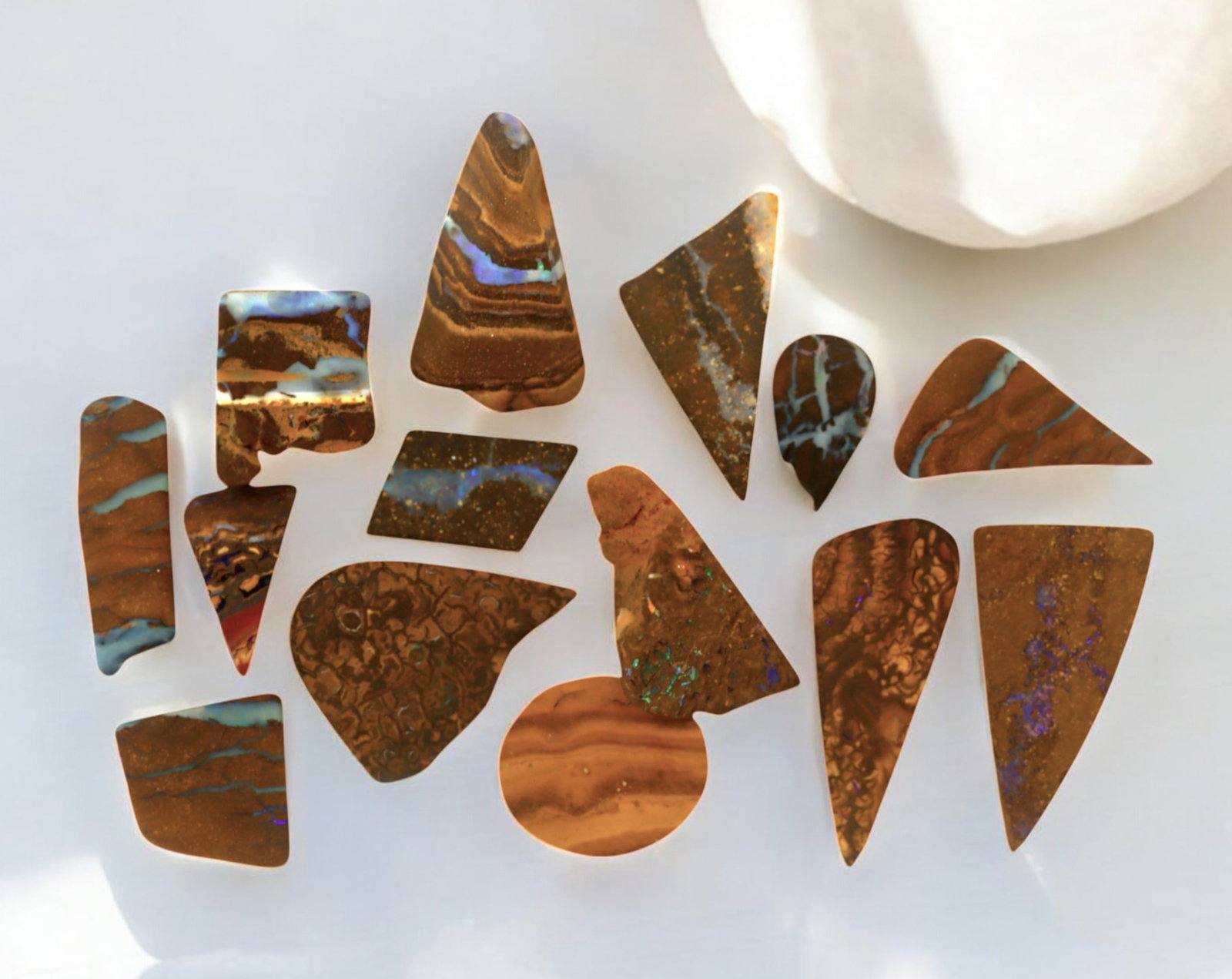 AUSTRALIA: Matrix Boulder Opal Preform Rough Lot, 18g, 1-2cm Each: A stunning selection of matrix boulder opal rough, sourced from Australia's renowned opal fields in Queensland. These preform-cut rough specimens display vivid flashes of blue, green, and purple opale