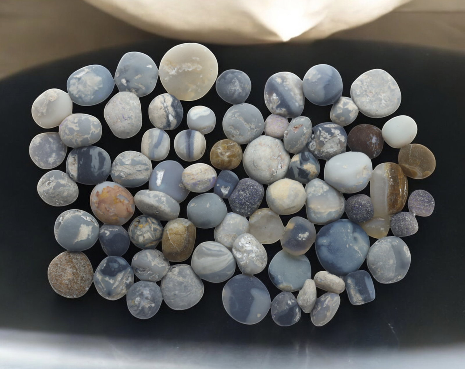 AUSTRALIA: Lightning Ridge Opal Preform Rough Lot - 73g, 5-15mm, Select Australian Specimens: A premium selection of Lightning Ridge opal preforms, weighing 73g, with individual pieces ranging from 5mm to 15mm. These naturally rounded and tumbled opals exhibit various blue, gray, and honey ton