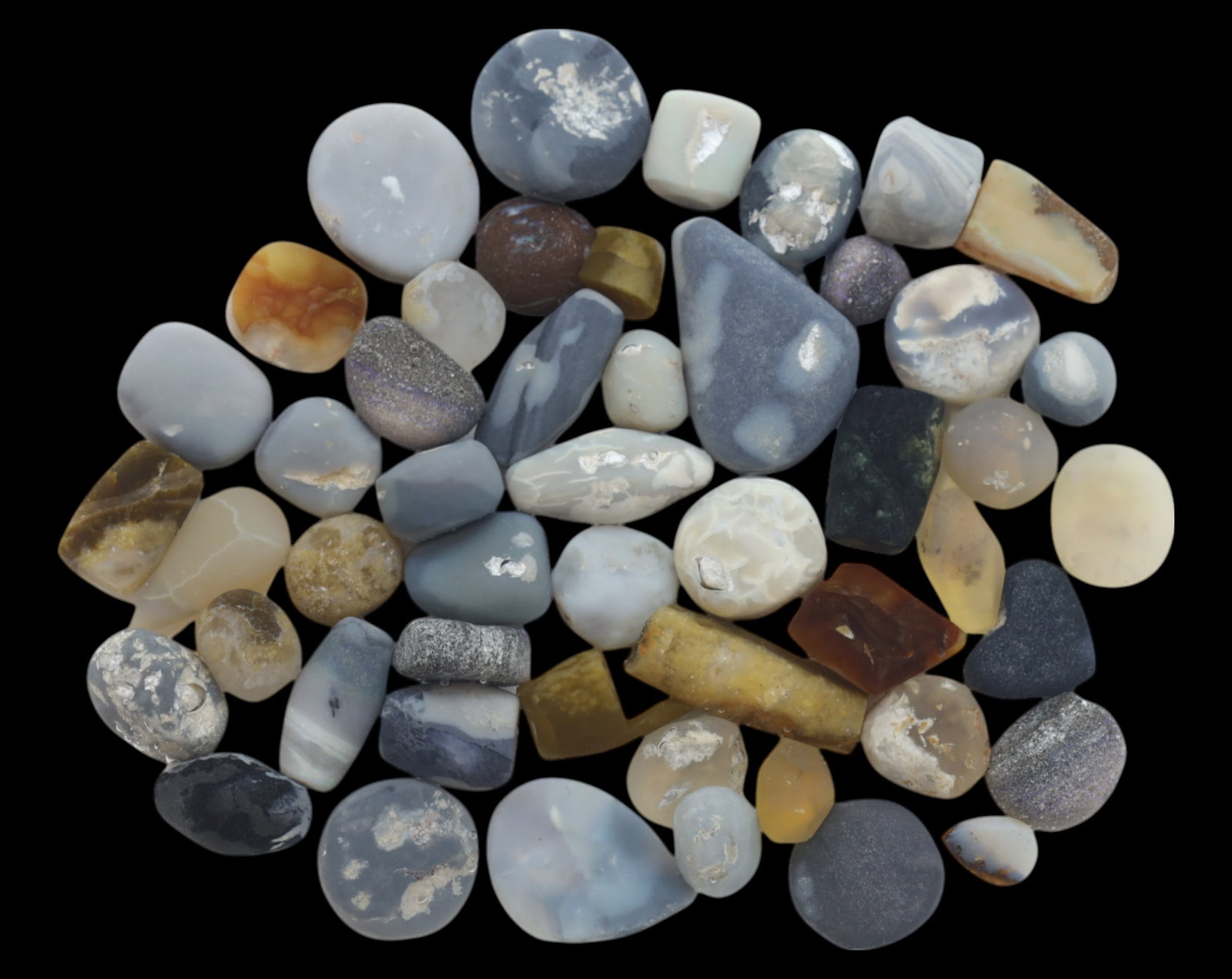 AUSTRALIA: Lightning Ridge Opal Preform Rough Lot - 70g, 10-25mm, Select Australian Specimens: A premium selection of Lightning Ridge opal preforms, weighing 70g, with individual pieces ranging from 10mm to 25mm. These naturally rounded and tumbled opals exhibit various blue, gray, and honey to