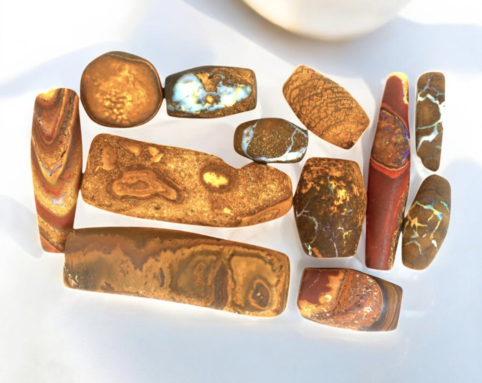 AUSTRALIA: Matrix Boulder Opal Preform Rough Lot, 63g, 1.5-4cm Each: A stunning selection of matrix boulder opal rough, sourced from Australia's renowned opal fields in Queensland. These preform-cut rough specimens display vivid flashes of blue, green, and purple opale