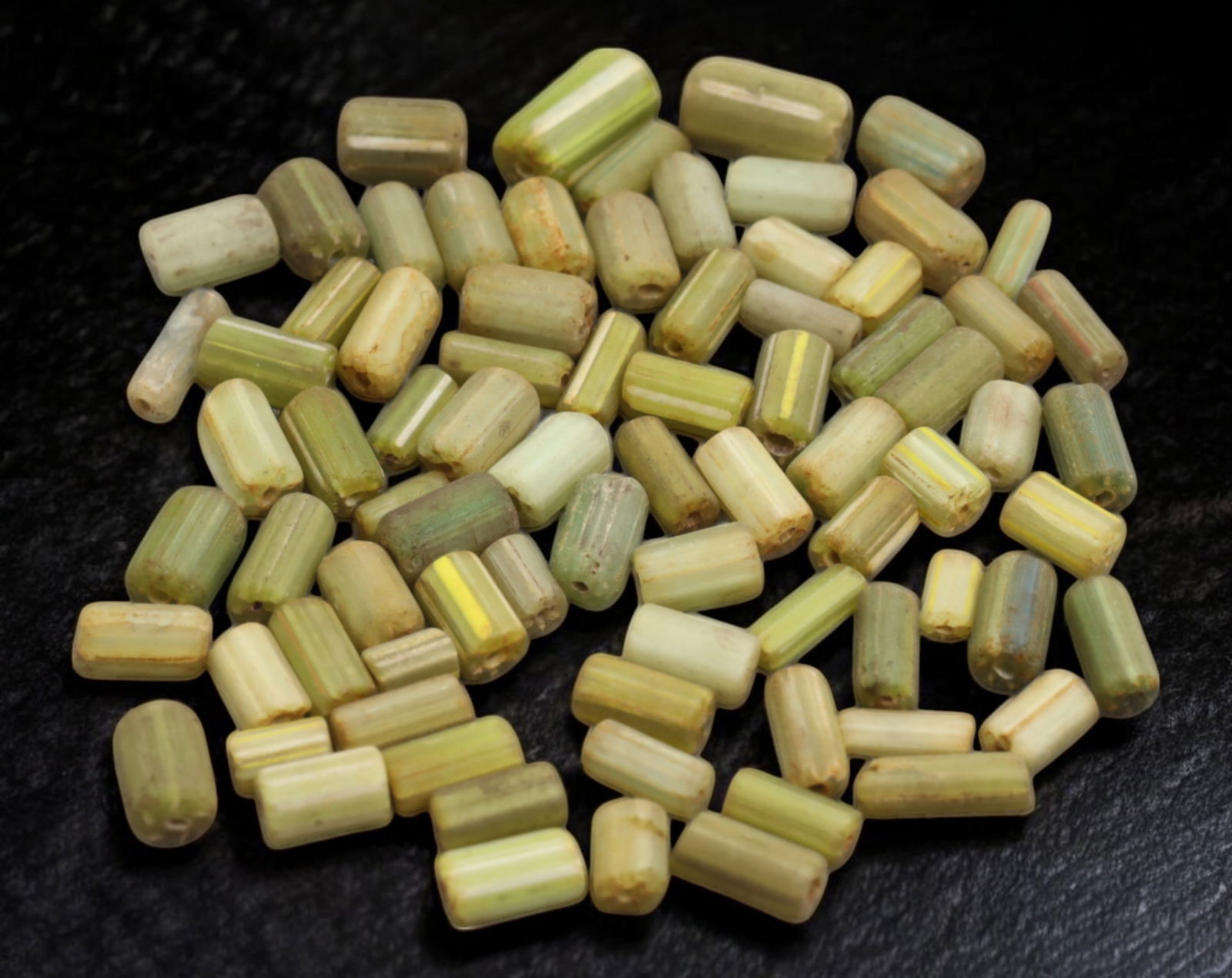 AFRICA: Antique Chevron Beads - 50g, 1-1.5cm, Handcrafted Trade Beads: A fine selection of antique African chevron beads, weighing 50g and measuring 1-1.5cm. These beads showcase distinct layered glasswork, with shades of green, yellow, and ivory, exhibiting the traditio