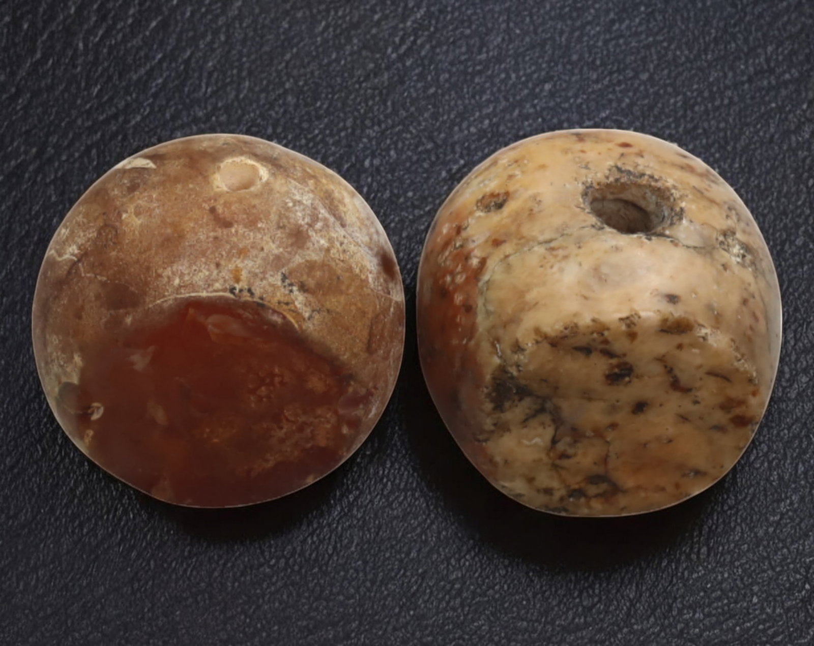 PERSIA: Sasanian Hemispherical Stamp Seal Pair - Agate, 2cm, 32g: A rare pair of Sasanian agate stamp seals, each meticulously shaped into a hemispherical form with a drilled perforation for suspension. Dating from the 3rd to 7th century AD, these seals were likely 