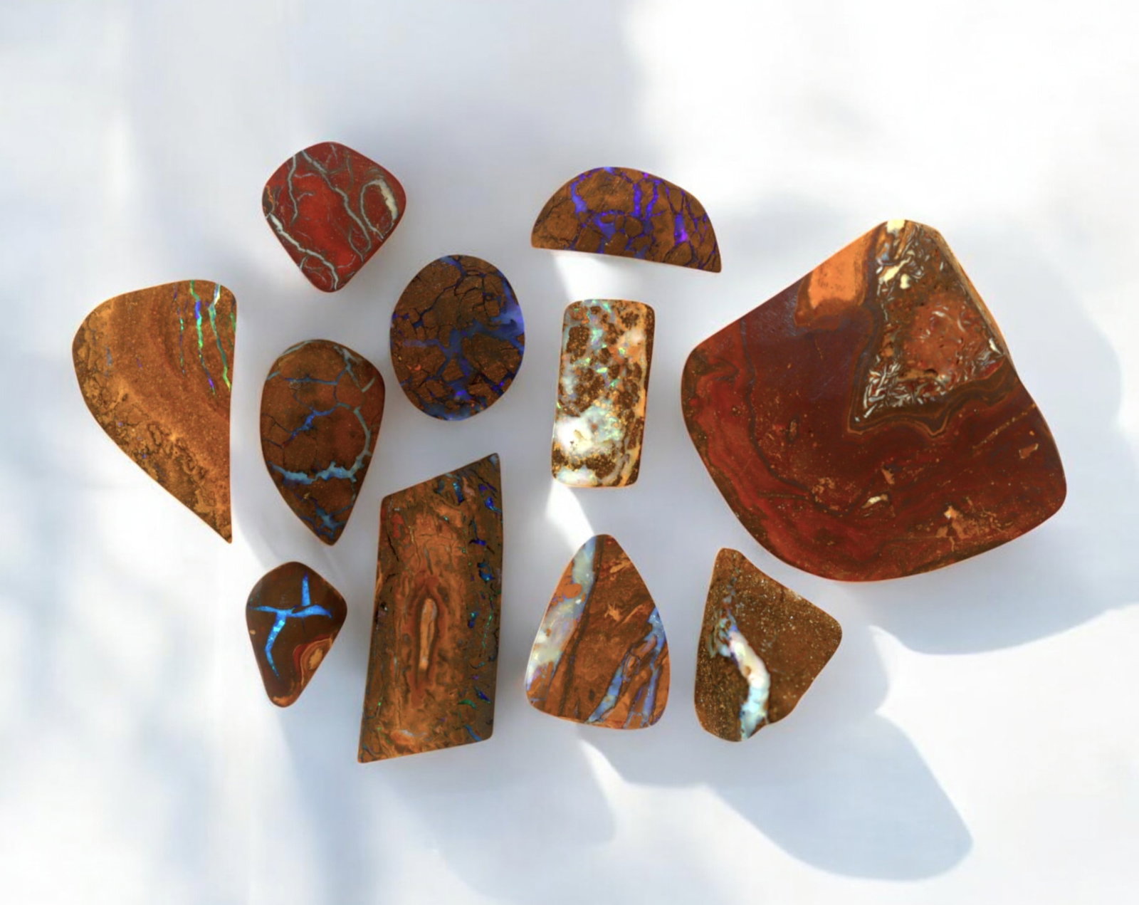 AUSTRALIA: Matrix Boulder Opal Preform Rough Lot, 28g, 1-3cm Each: A stunning selection of matrix boulder opal rough, sourced from Australia's renowned opal fields in Queensland. These preform-cut rough specimens display vivid flashes of blue, green, and purple opale